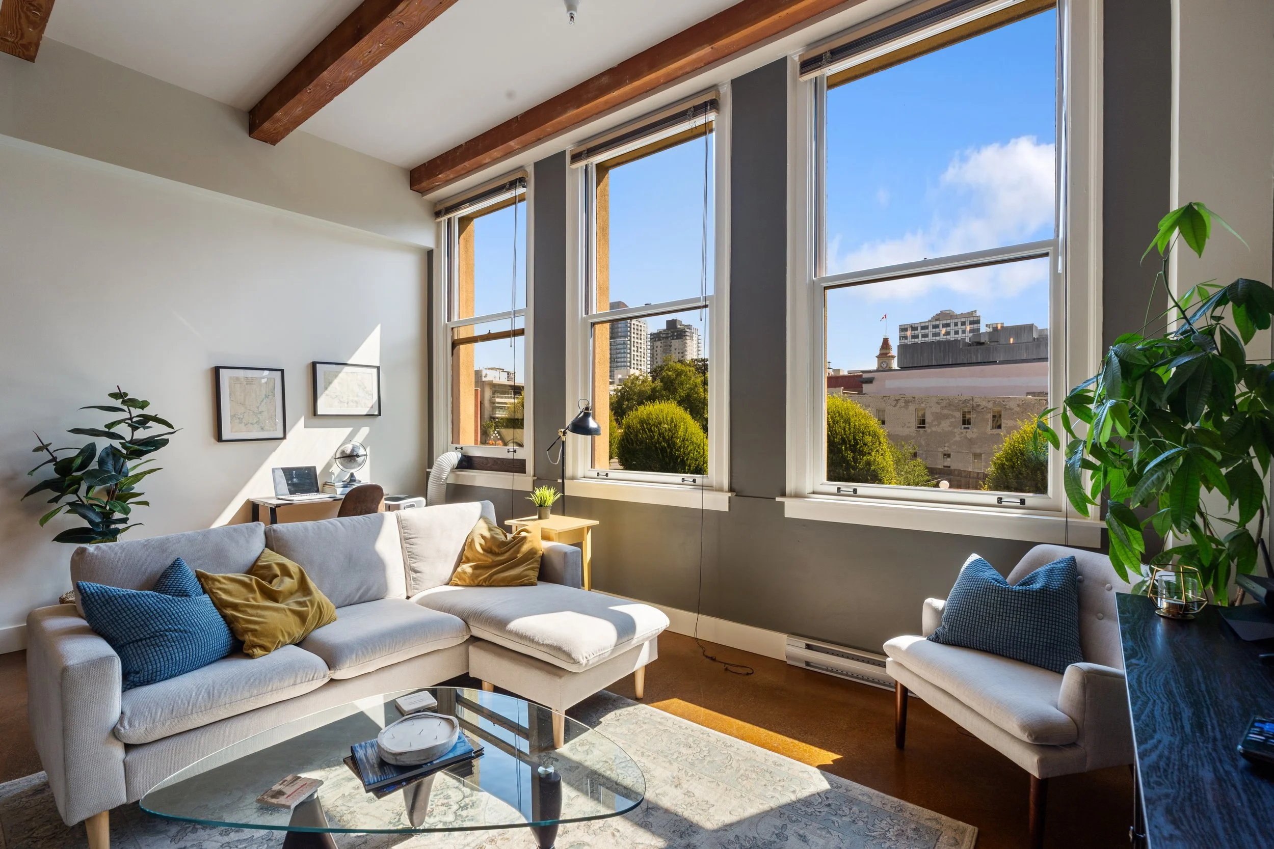 Bright modern living room with large windows and natural light photographed for a Victoria BC real estate listing by Bancks Media.
