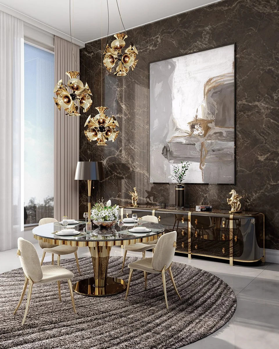Modern dining room with a round marble table, six beige upholstered chairs, a black and gold sideboard, an abstract wall art, a black floor lamp, and a chandelier made of gold-colored metallic flower-like fixtures. Large window with white curtains and a gray rug beneath the table.