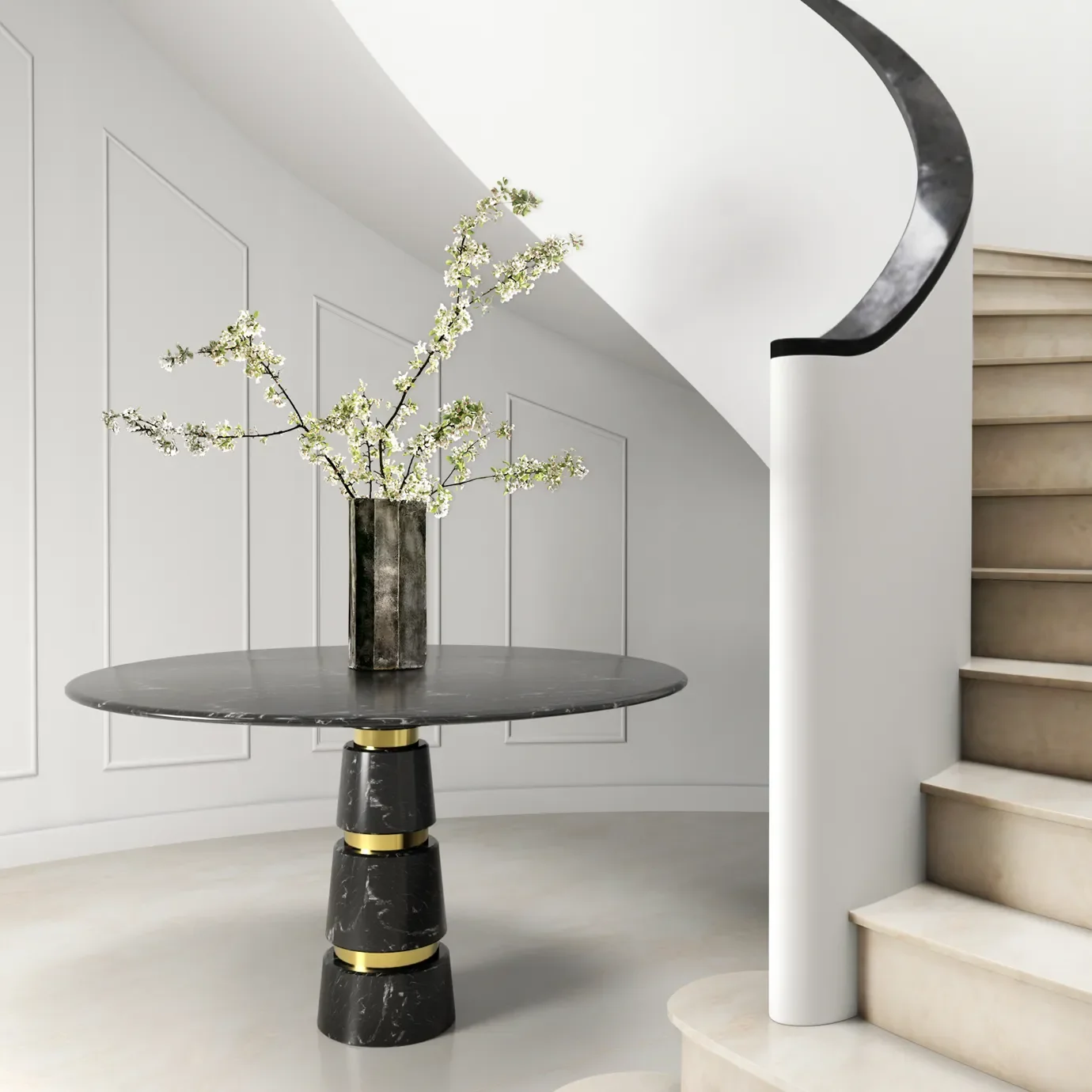 A modern interior with a black marble round table, a tall black marble vase with white blossoms, white walls with decorative paneling, and a staircase with beige steps and a black and white curved handrail.