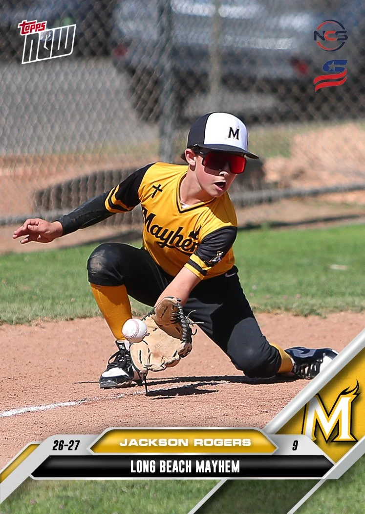 Young boy smiling, wearing a yellow sports jersey with 'Mayhem' written on it, a black cap with yellow accents, and white pants against a plain white background.