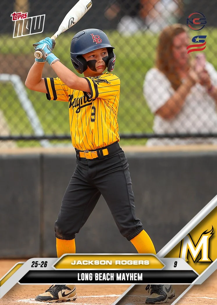 Young boy smiling, wearing a yellow sports jersey with 'Mayhem' written on it, a black cap with yellow accents, and white pants against a plain white background.
