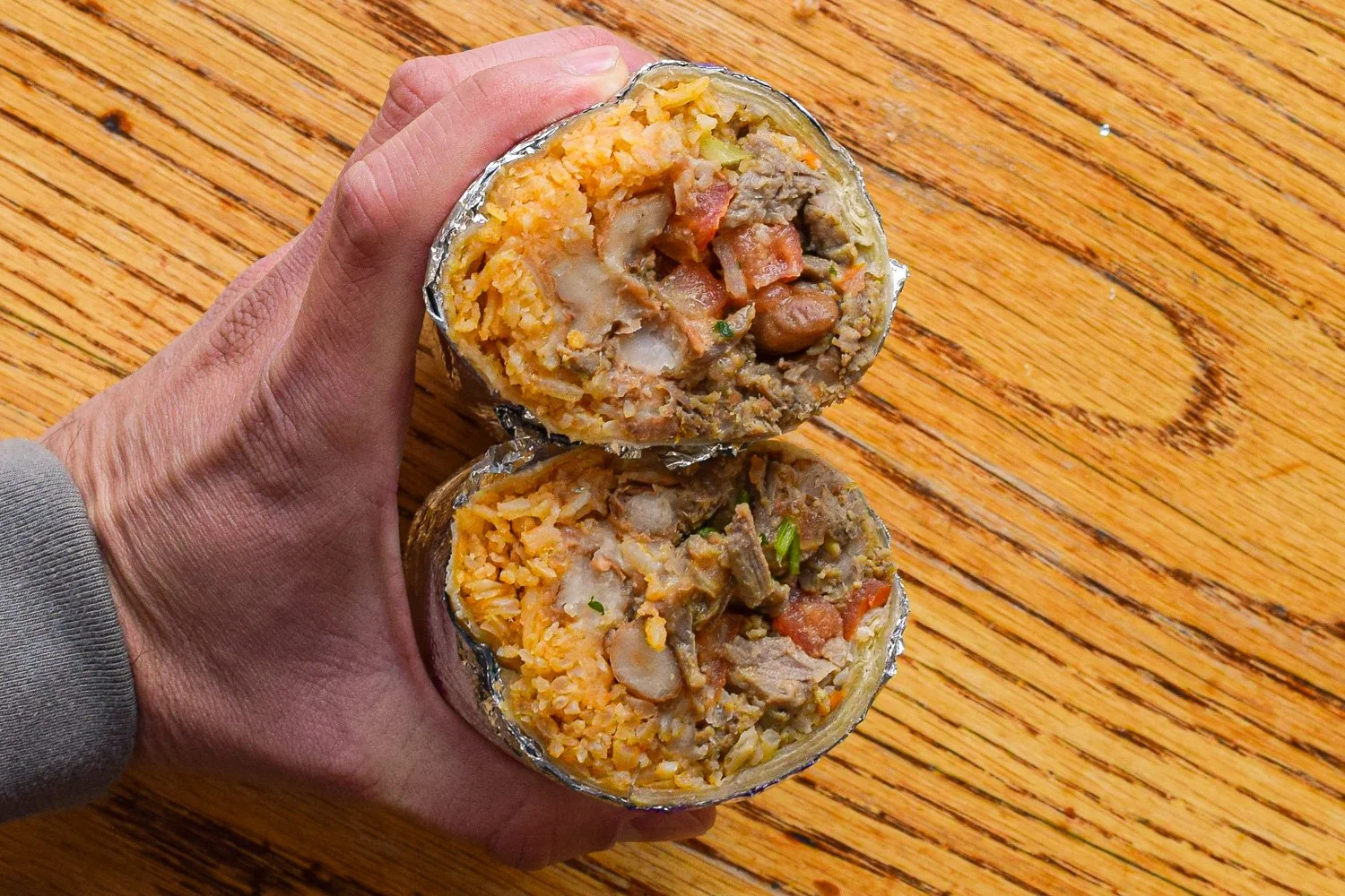 Close-up of a cut carne asada burrito from El Toro Taqueria with mild fillings and a simple balance of ingredients.