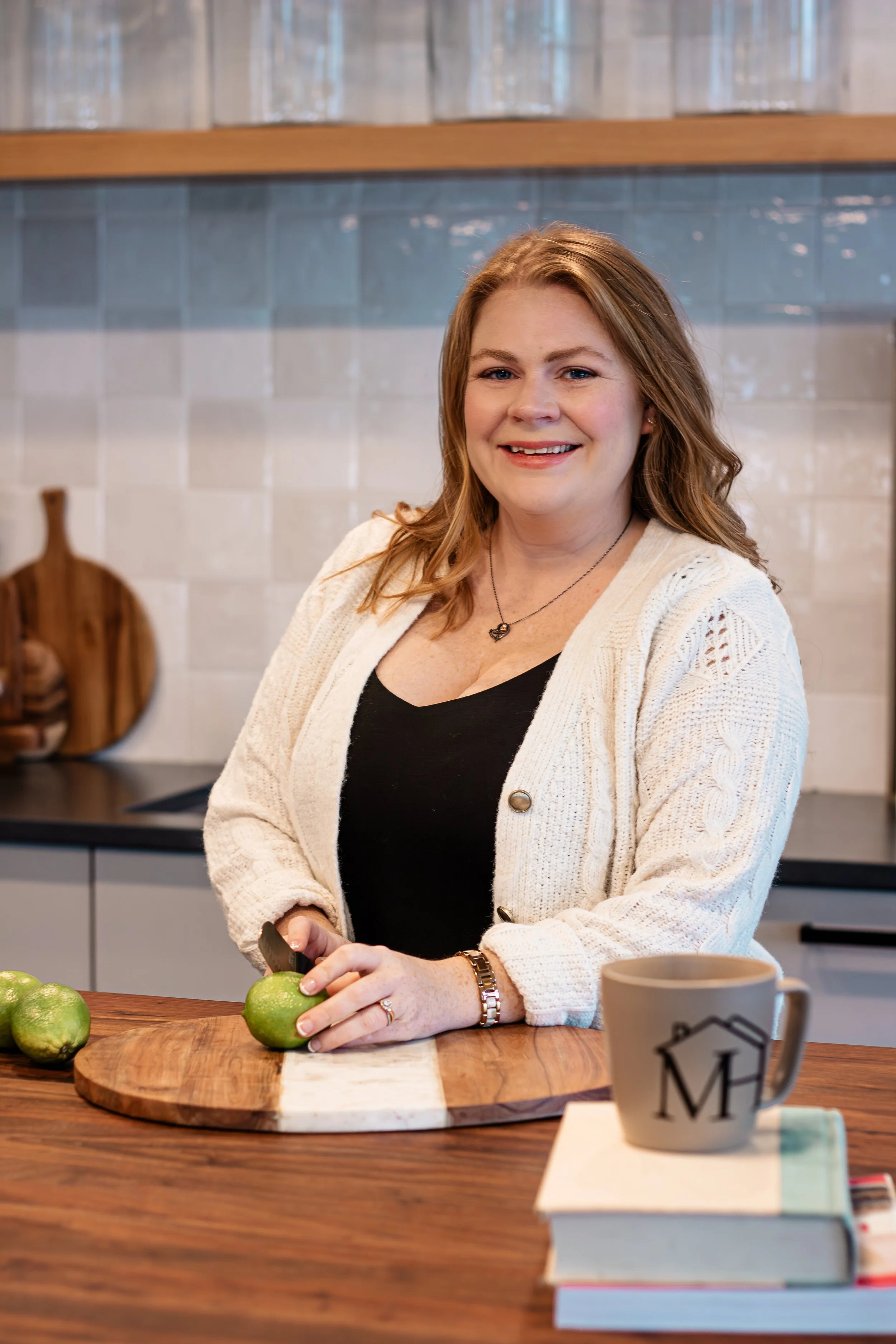 A pediatric dietitian and kids nutritionist preparing a lime on a cutting board in a modern kitchen.