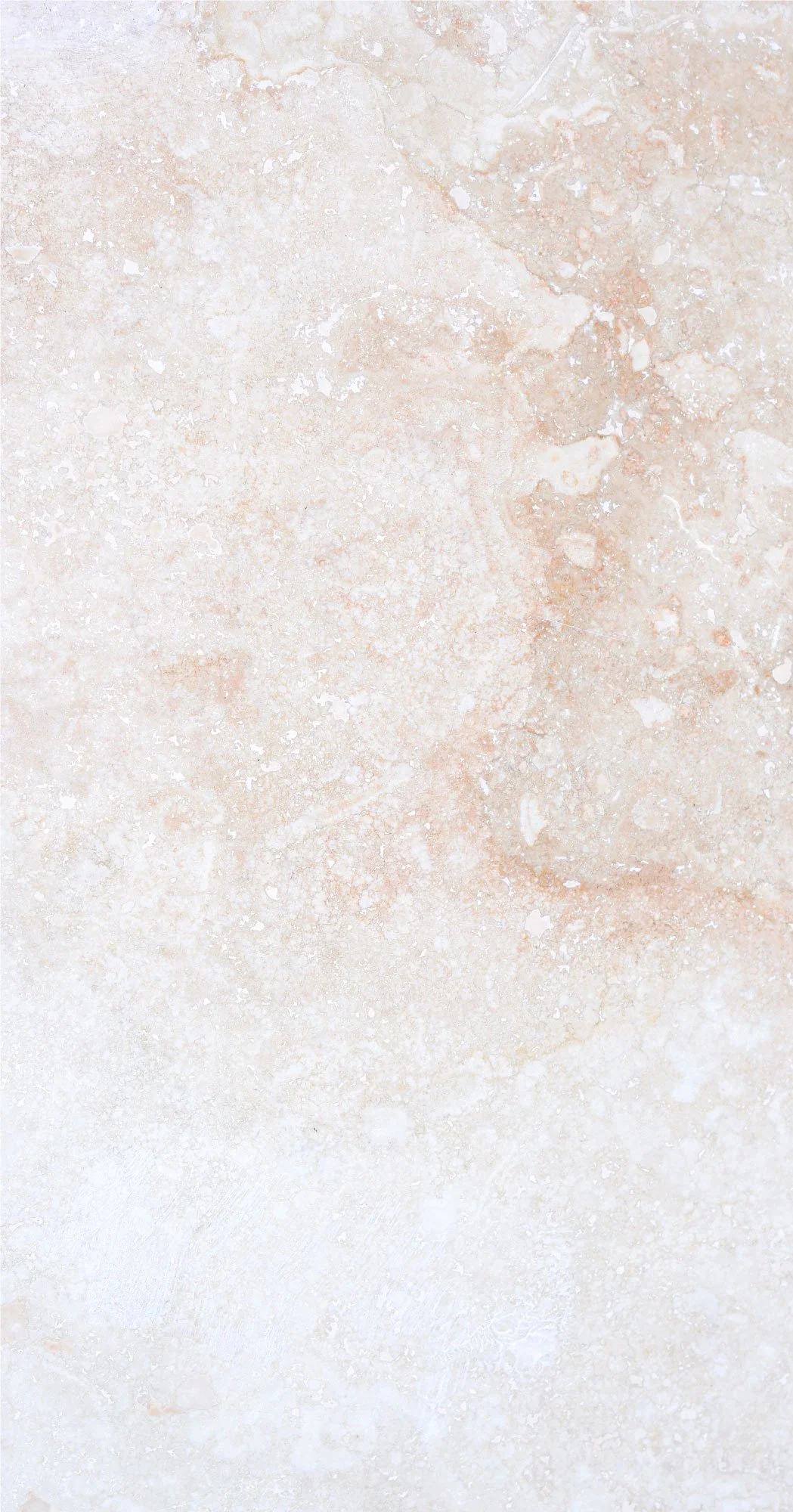 Close-up view of a beige and light pink marble surface with natural veining and speckling.