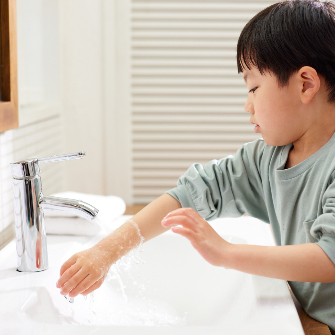 Child washing hands properly to boost immune system and prevent illness