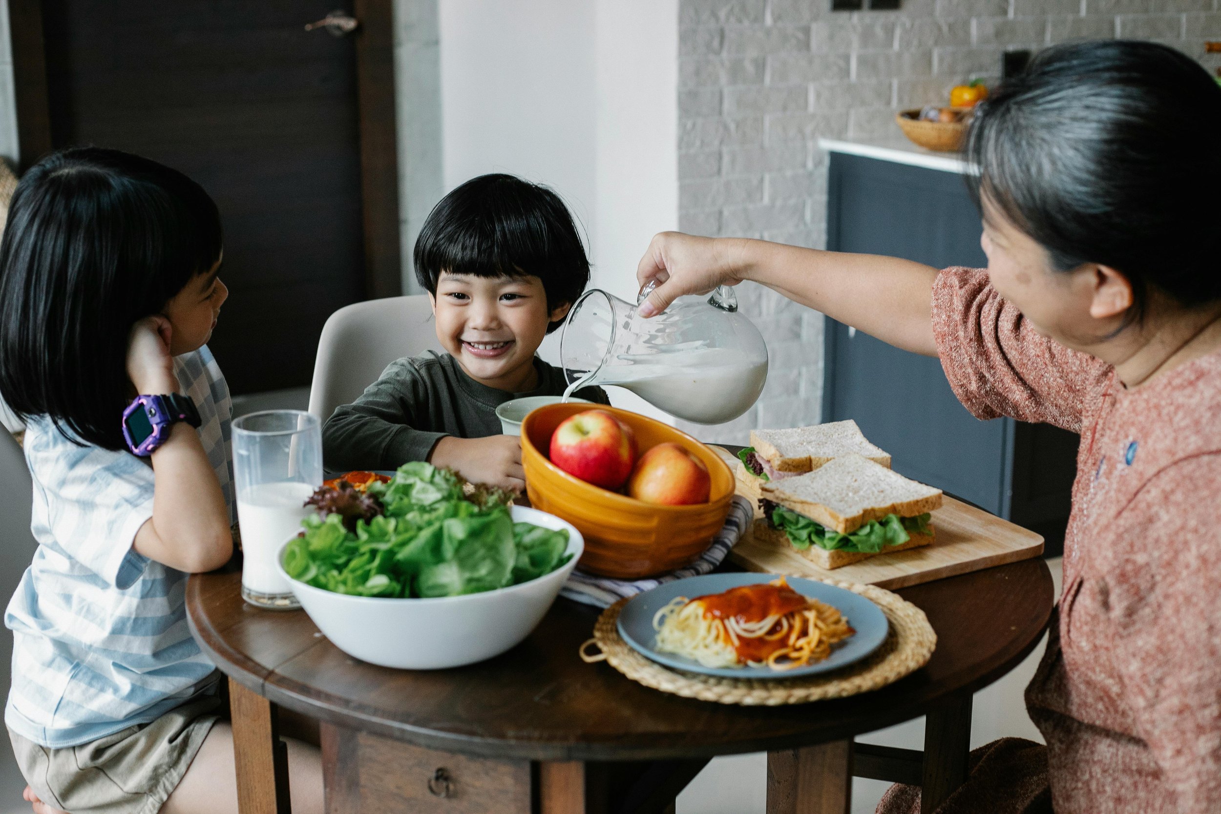 Family eating healthy balanced meal together showing importance of good nutrition for kids