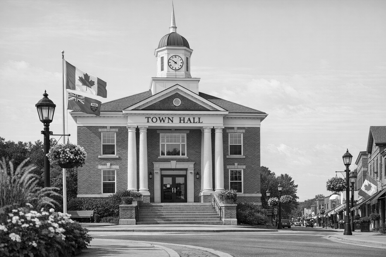 Black and white image of a town hall building with a clock tower, flags, and street lamps in a small town. Who creates websites for political campaigns?