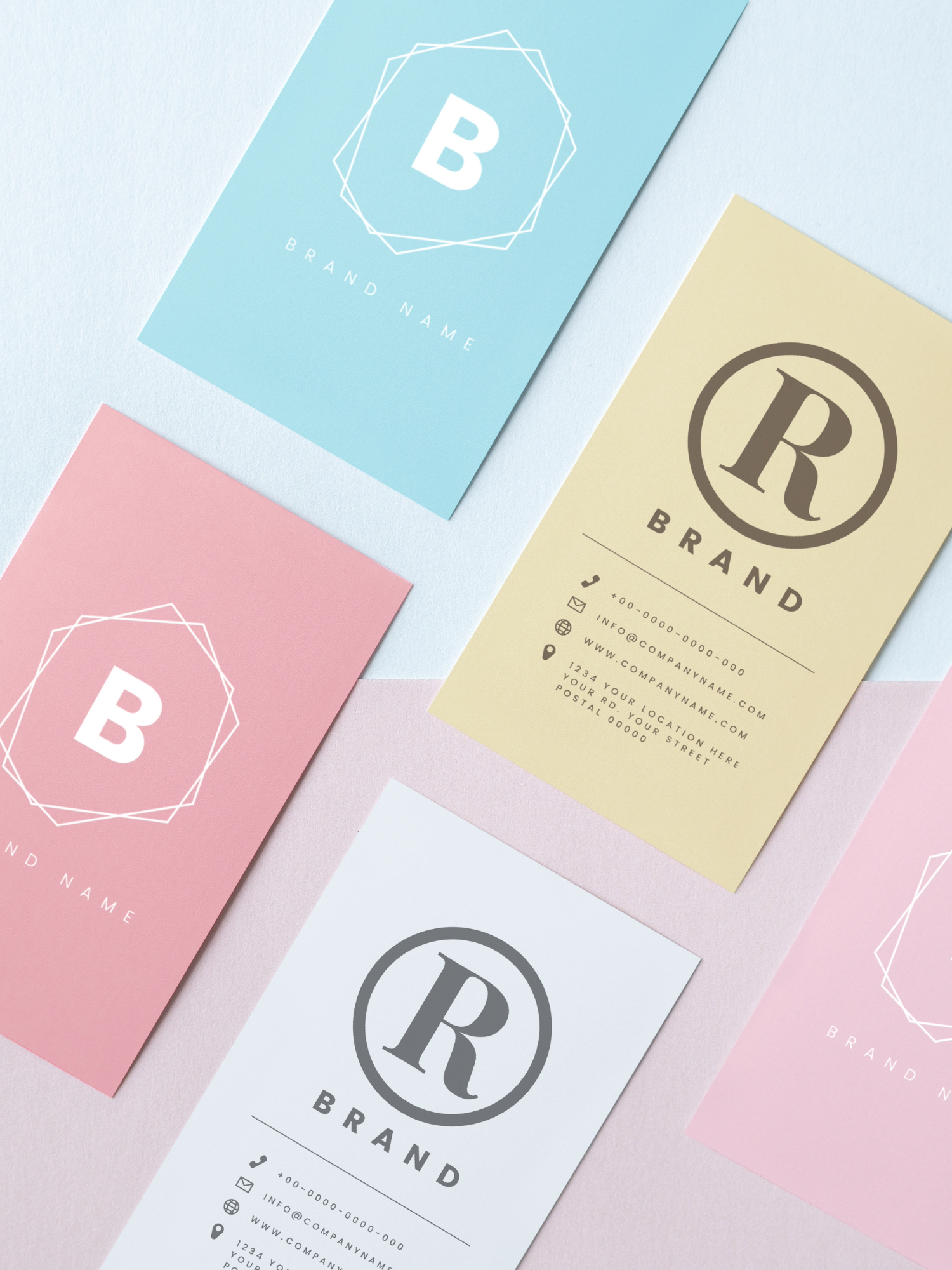 Multiple business cards in pastel colors, with some displaying a large letter 'B' inside a geometric shape, and others with a logo 'R' inside a circle and contact information.