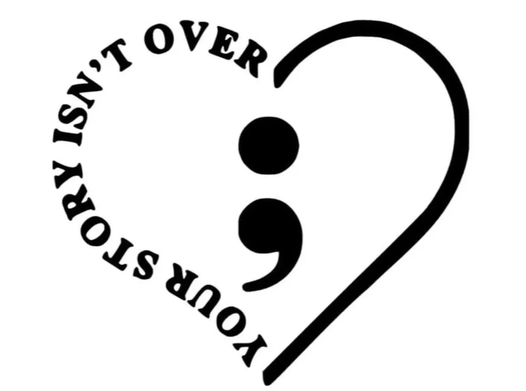 A heart-shaped design with a semicolon in the center. The phrase "You aren't over" curves along the left side of the heart.