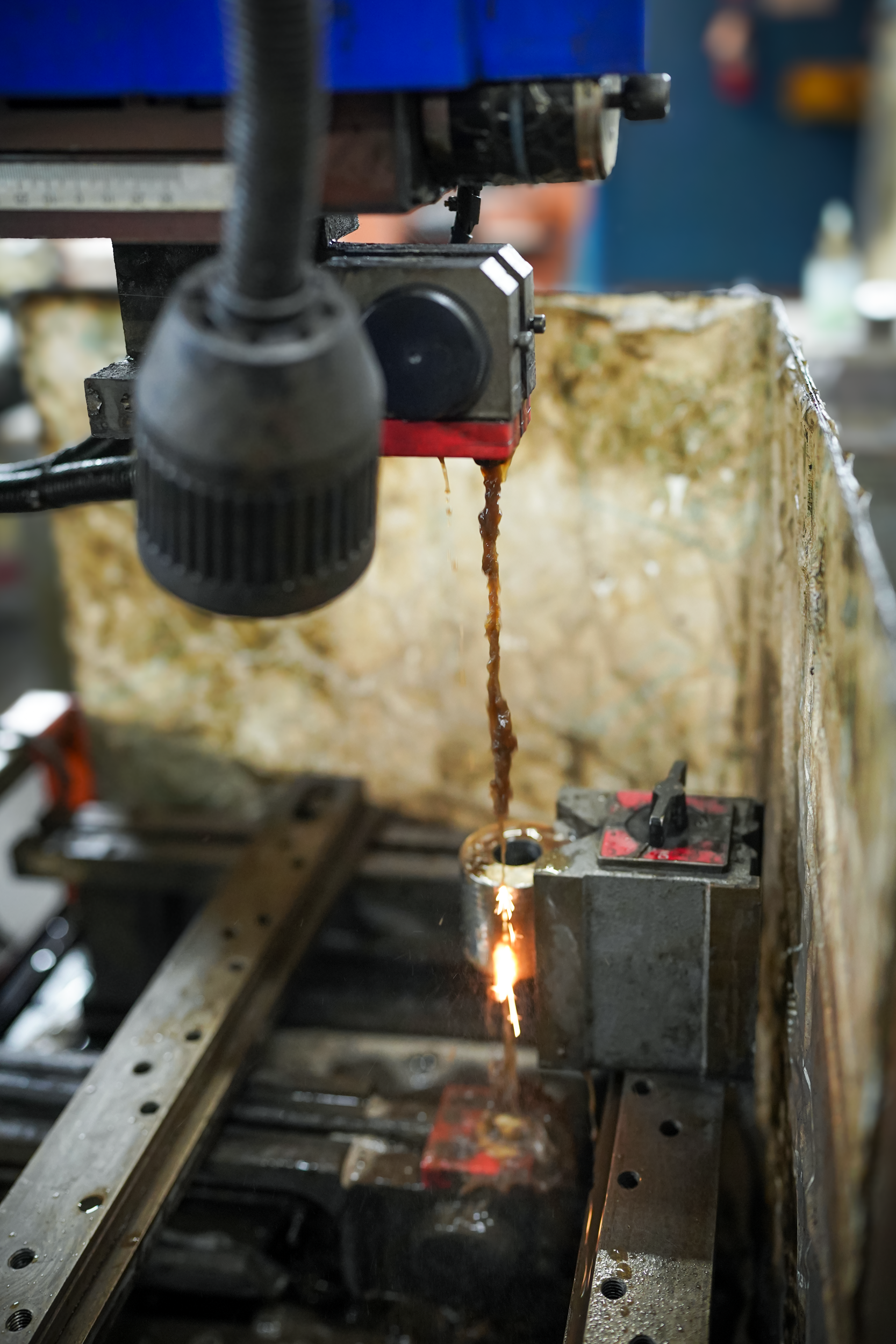 A CNC machine cutting metal with sparks flying from the cutting area.