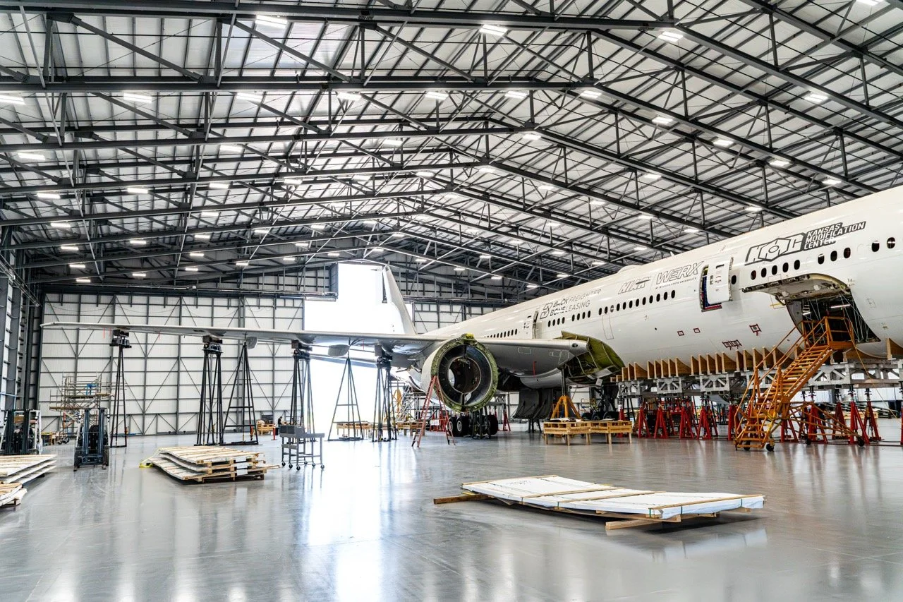 Airplane parked in hangar being worked on