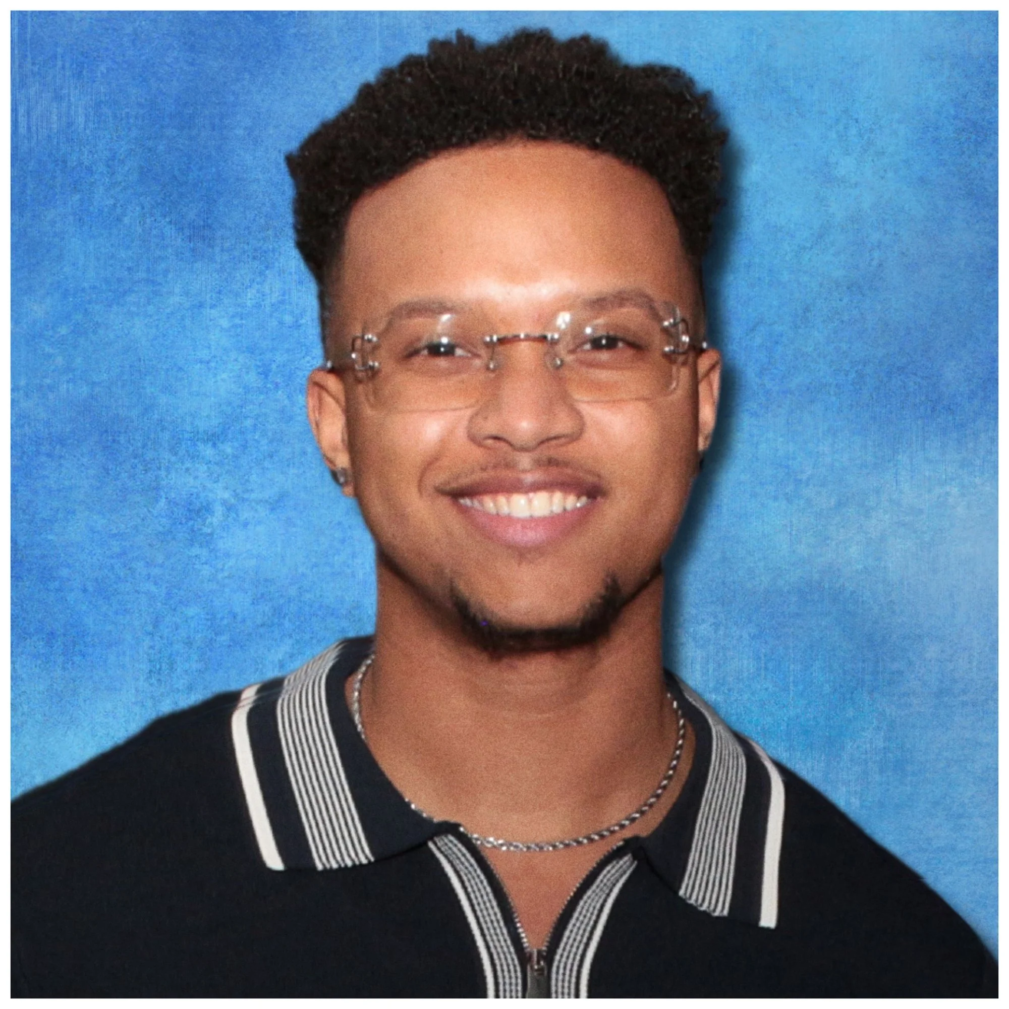 happy black african american latinx Smiling young man with glasses, wearing a black shirt with striped collar, against a blue background.