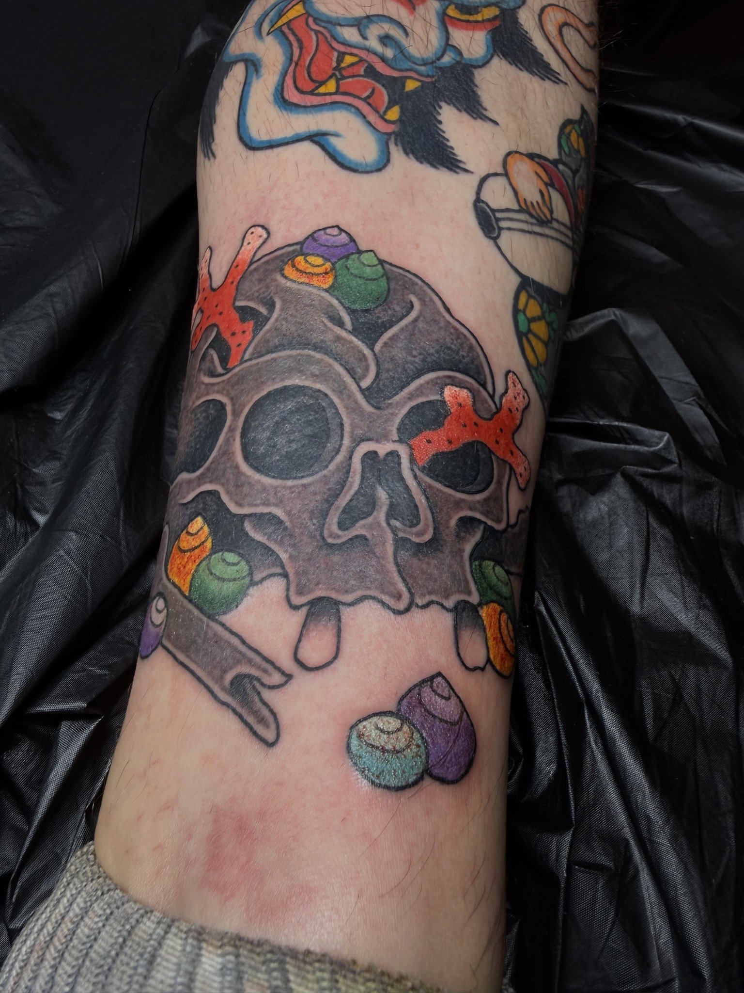 Josh Carter, @joshcartertattoo Traditional Japanese Skull Ankle Tattoo done at Dame of the West Tattoo in Scottsdale, Arizona.