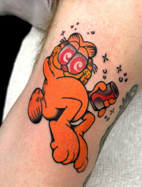 Chris Naderer American Traditional Full Color Garfield with Diet Coke tattoo on the arm tattooed at Dame of the West Tattoo in Scottsdale, Arizona