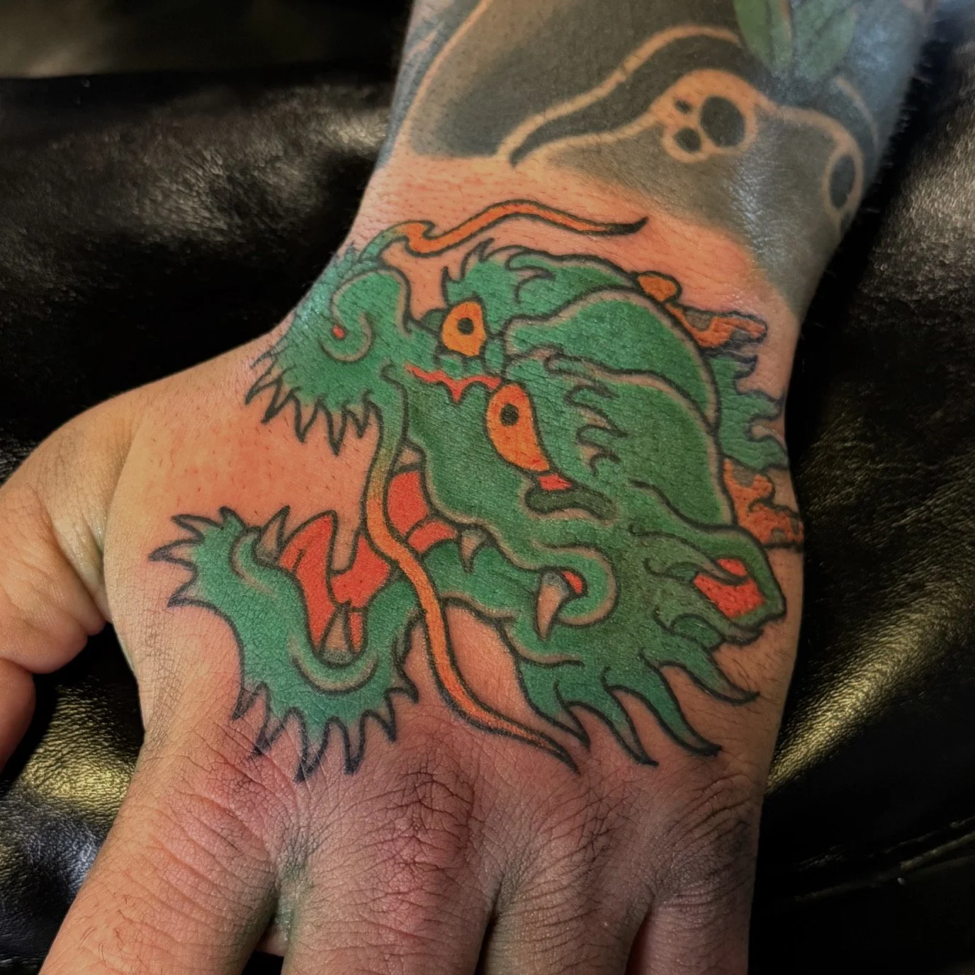 Josh Carter, @joshcartertattoo Traditional Japanese Dragon on Hand Tattoo done at Dame of the West Tattoo in Scottsdale, Arizona.