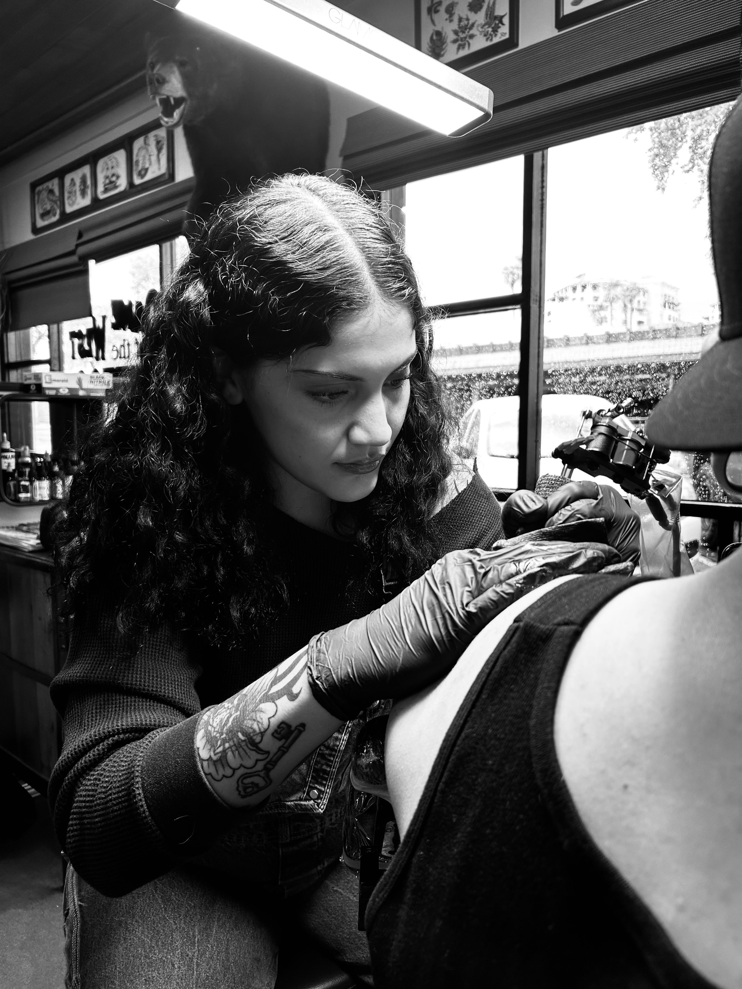 The talented and professional tattoo artist Mel Gonzalez, @theemelodic is pictured tattooing her client at Dame of the West Tattoo in Scottsdale, Arizona.