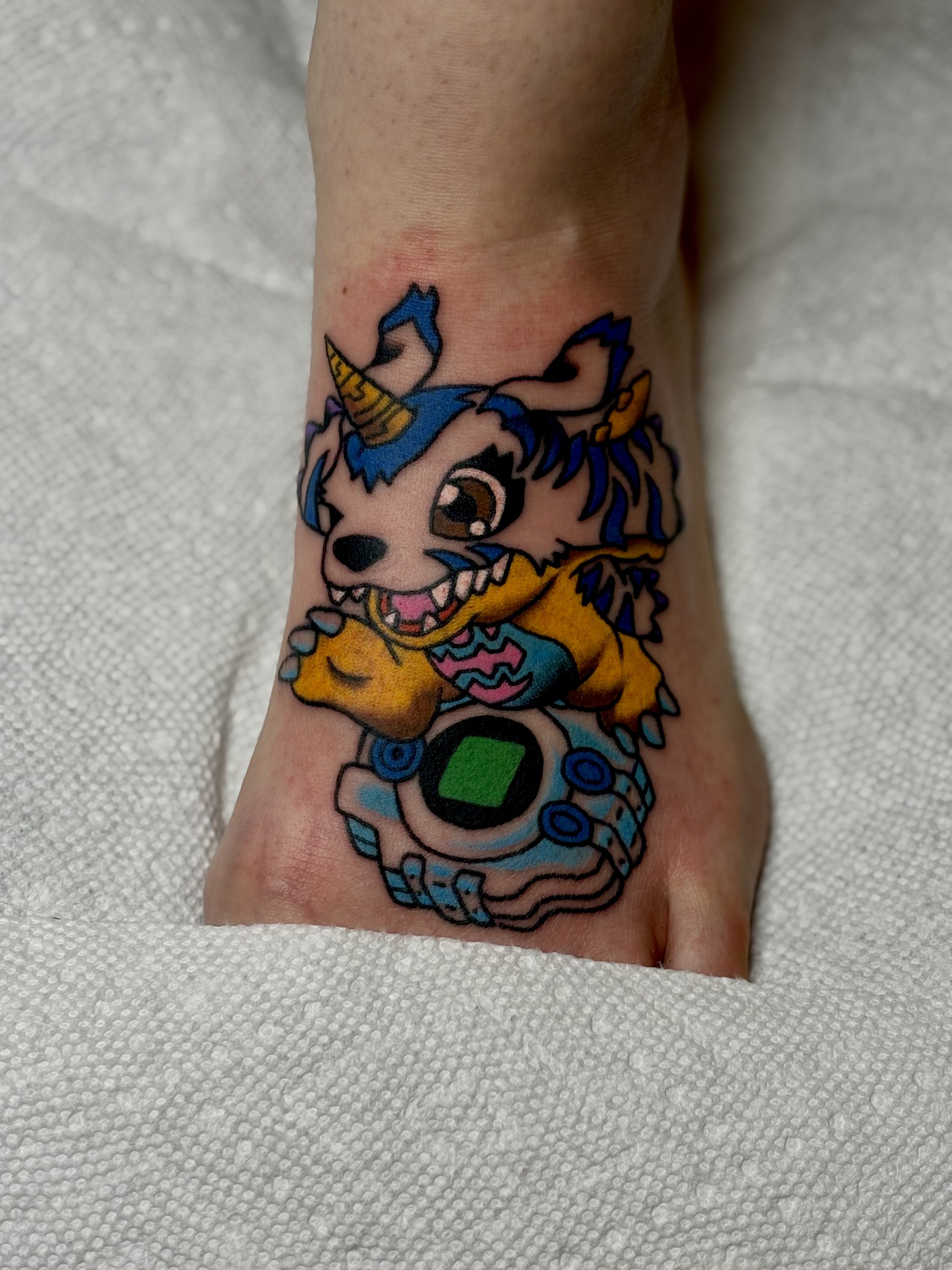 Jonas Richards, @jonasrichardstattoo Traditional Style Digimon Character Tattoo on the foot done at Dame of the West Tattoo in Scottsdale, Arizona.