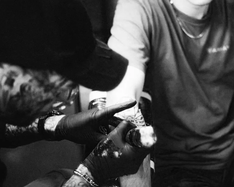 A client of Dame of the West Tattoo located in the heart of Old Town Scottsdale, Arizona is getting a tattoo on their upper arm by professional tattoo artist, Kyle Grand.