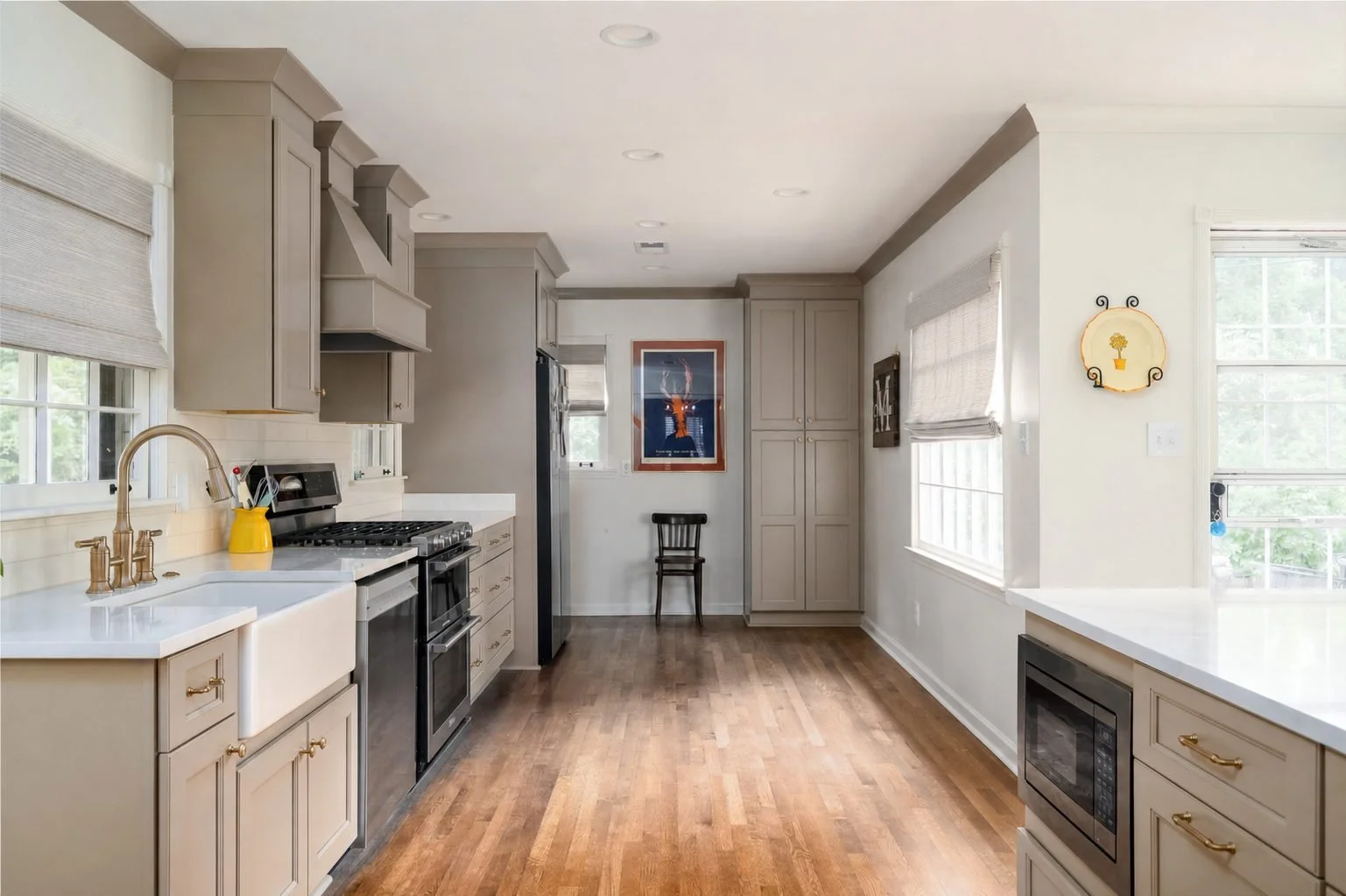 Galley Kitchen with Taupe Cabinets and Wood Floors