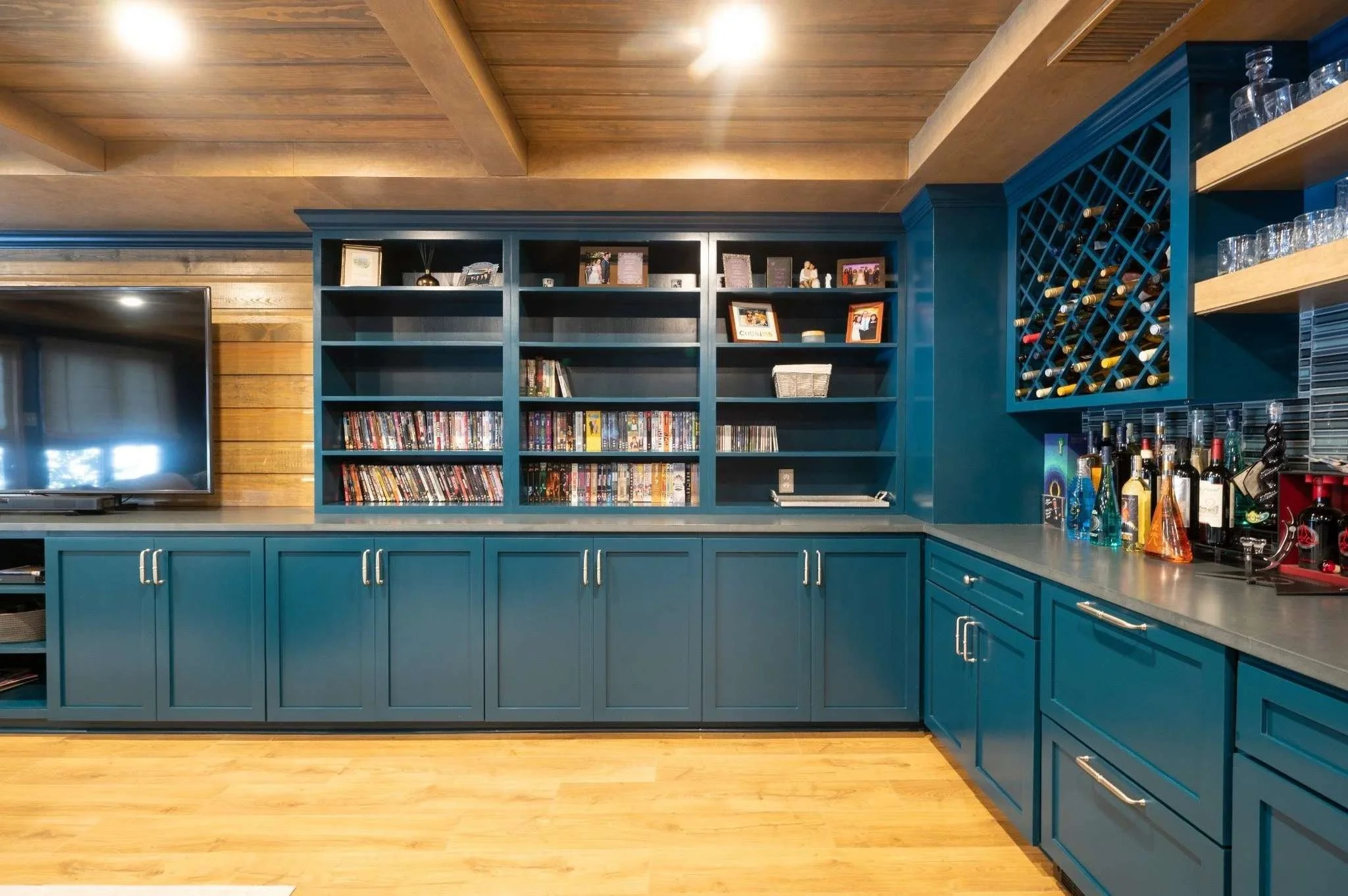 Custom basement bar and entertainment area with built-in cabinetry by Robbins Construction in Memphis, Tennessee