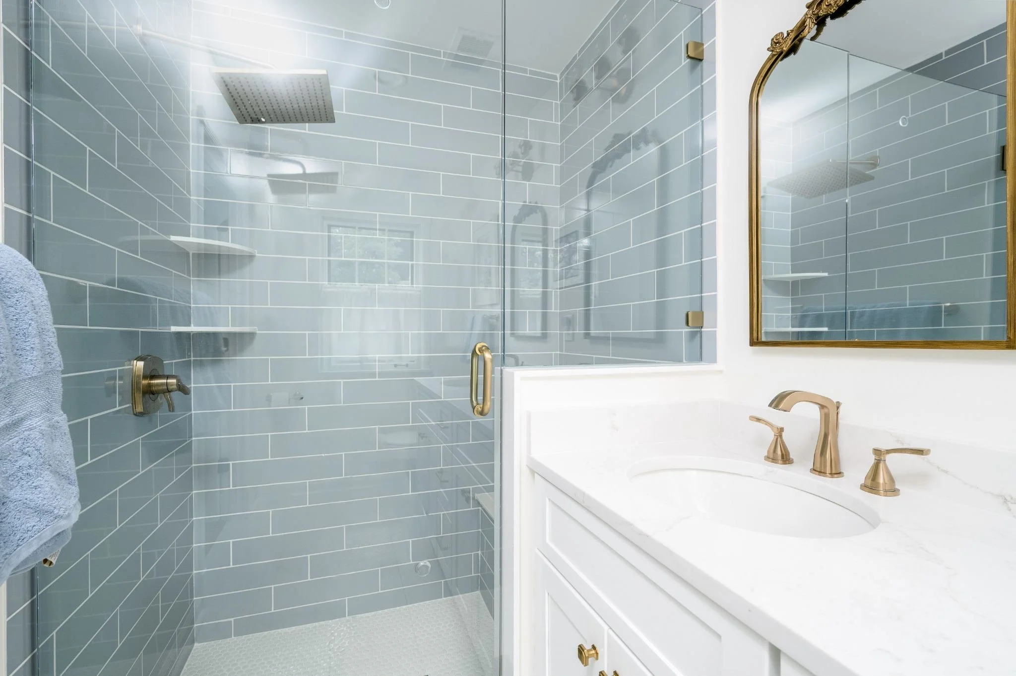 Blue Tile Walk-In Shower and White Vanity