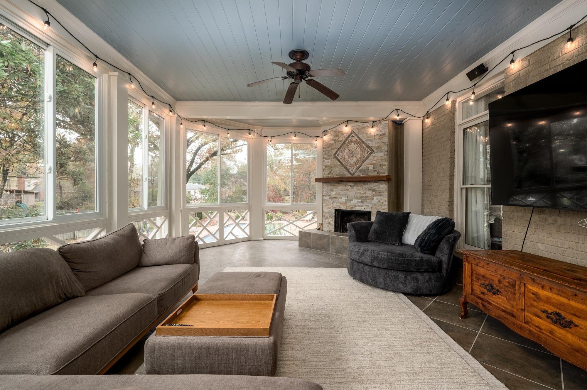 A wide view of the McCalla screened-in porch showcasing the open layout, cozy seating area, and seamless connection to the outdoors.
