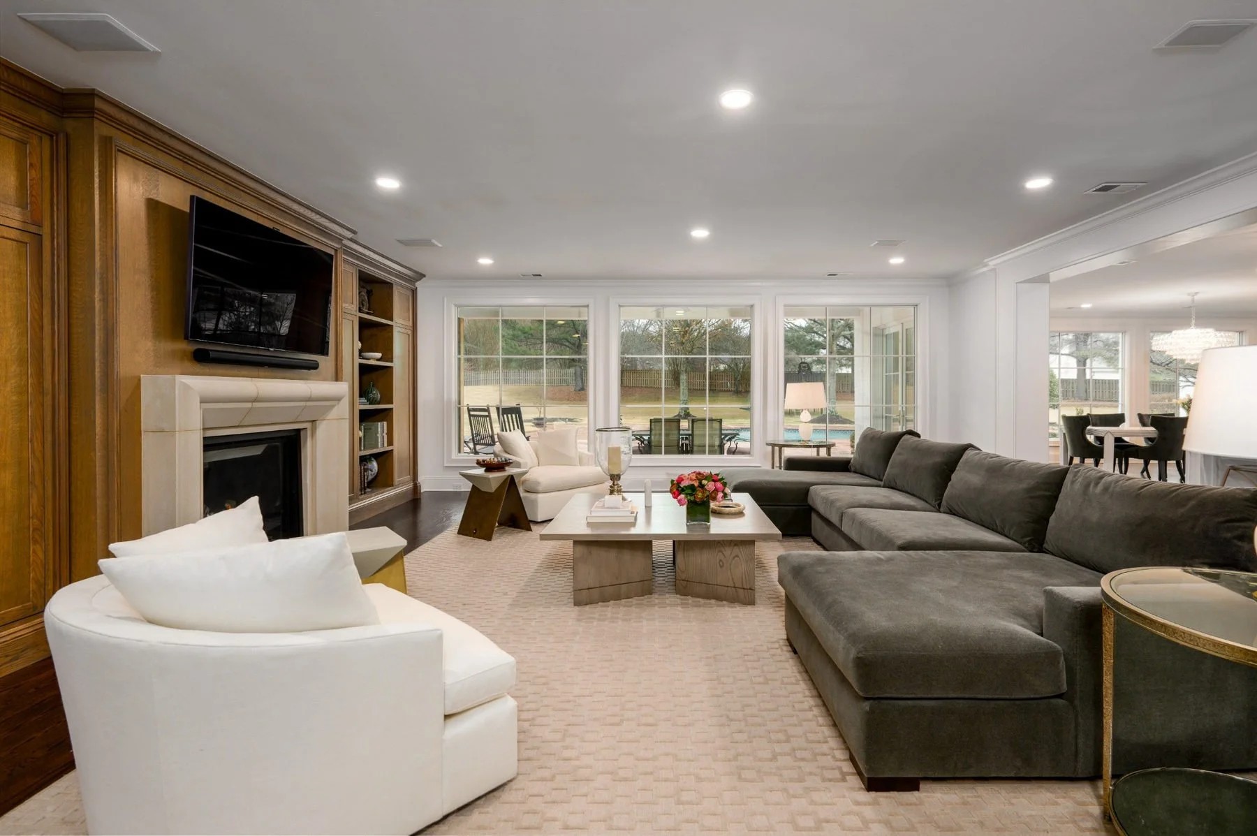 Spacious living room remodel in Germantown, TN, featuring custom wood built-ins, a fireplace, large windows, and an open layout designed for family gatherings.