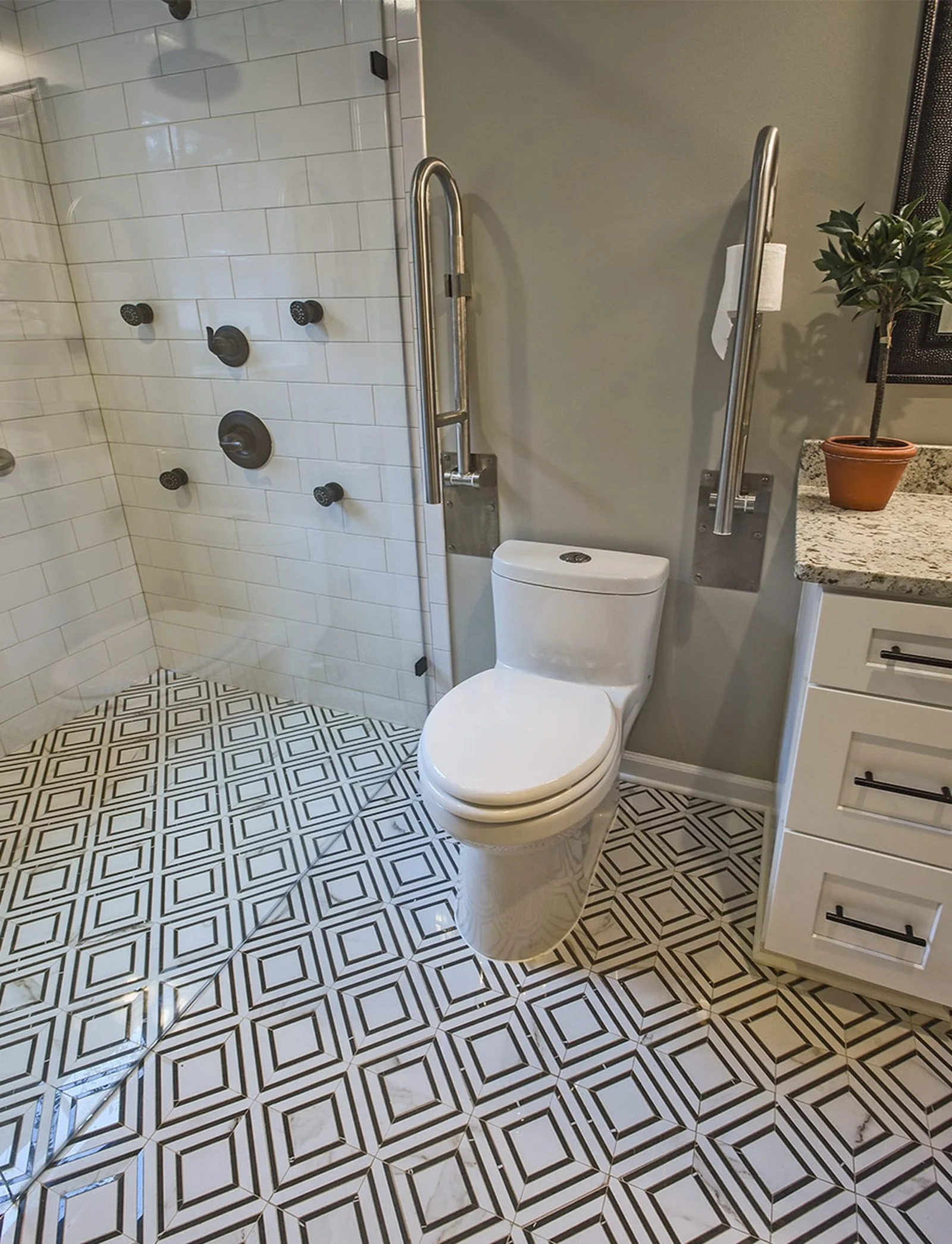 ADA-friendly bathroom remodel with accessible vanity, comfort-height toilet, grab bars, and curbless shower design for improved mobility and safety