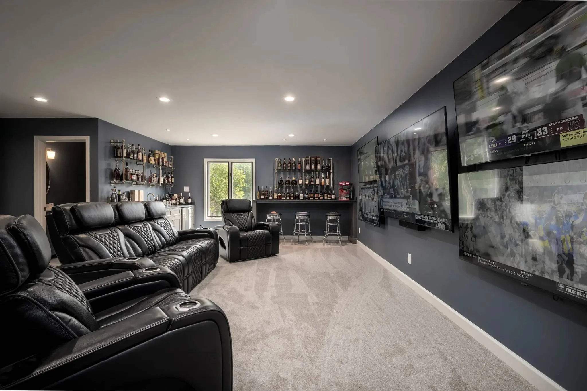 Custom home theater addition with recliner seating and entertainment wall by Robbins Construction in Memphis, Tennessee.