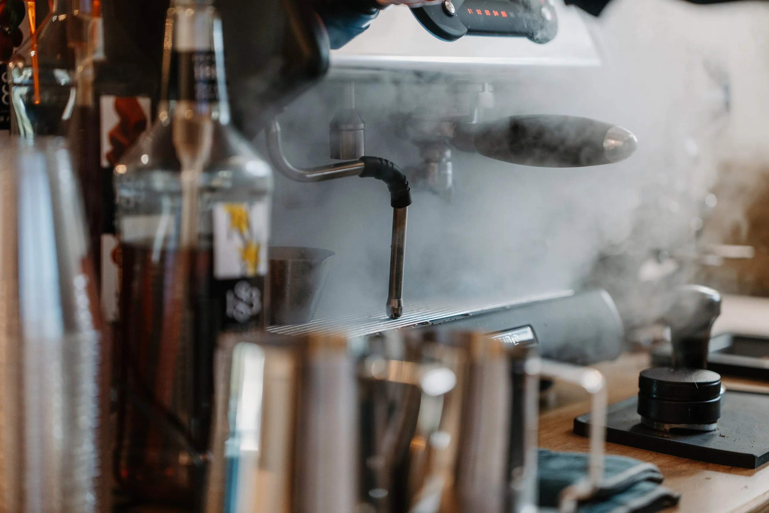 Steam filling the air around espresso bar