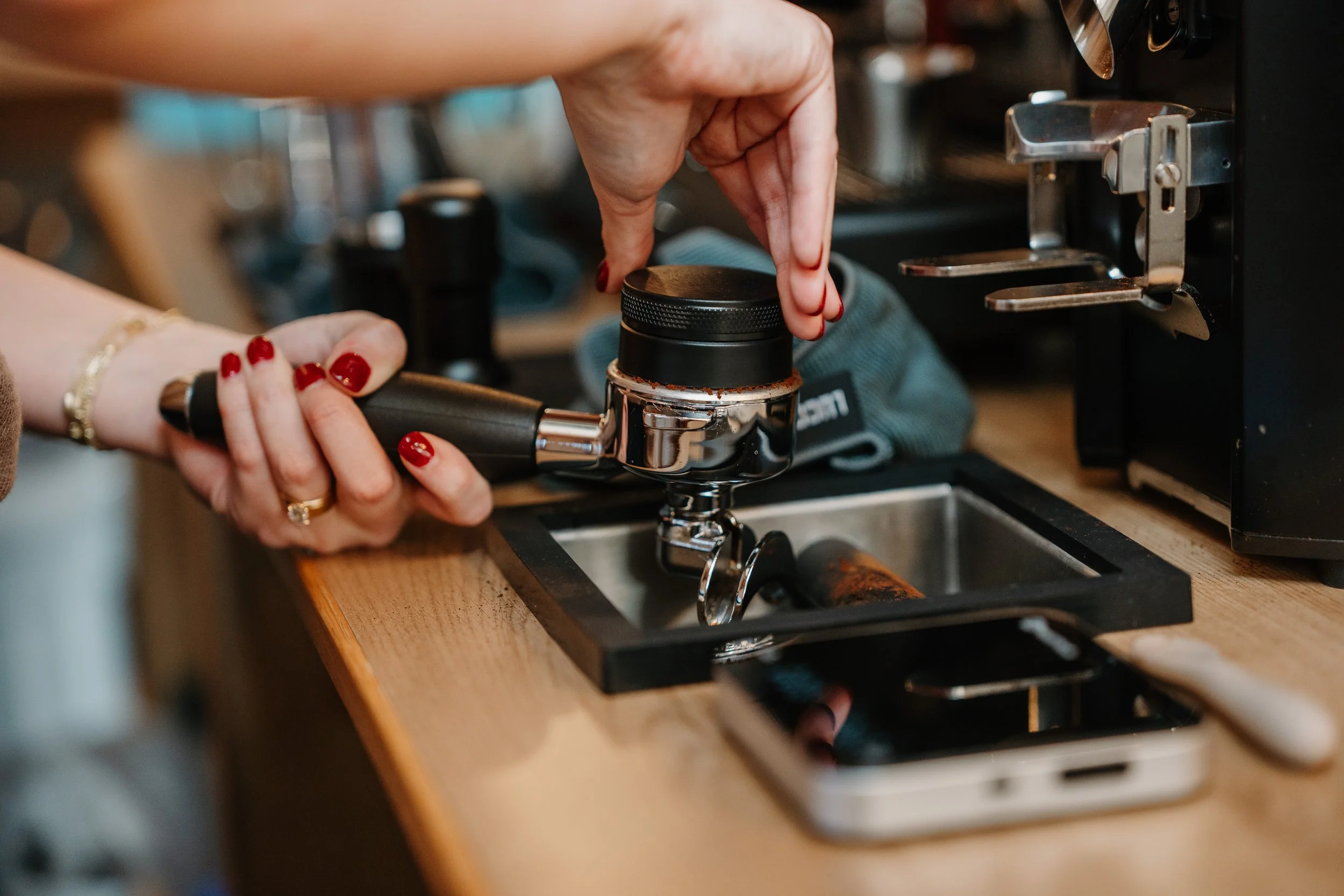 barista distributing espresso at an event in Buda