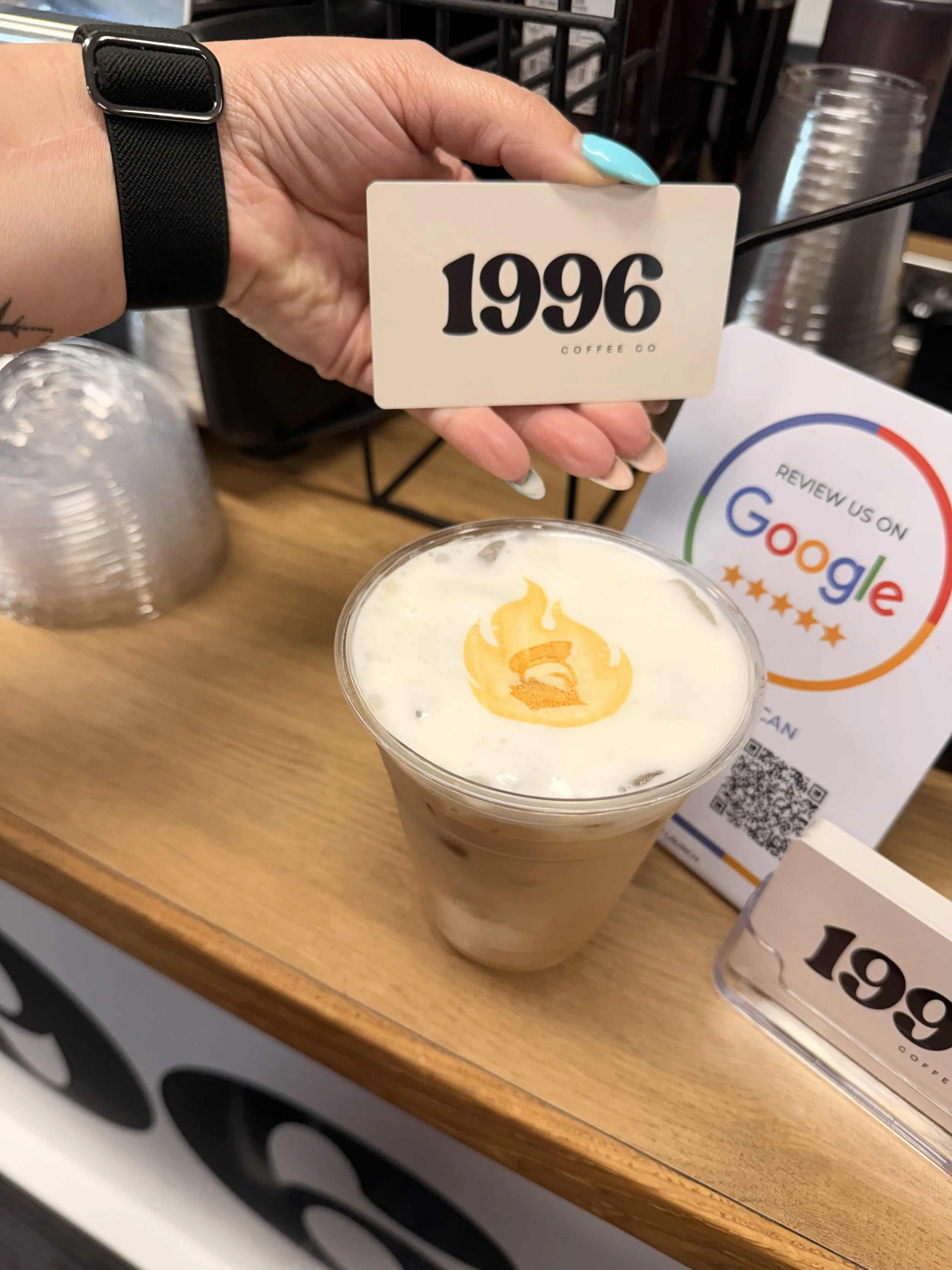 branded espresso drink with latte art from 1996 coffee co mobile coffee cart in San Antonio with Google review display.