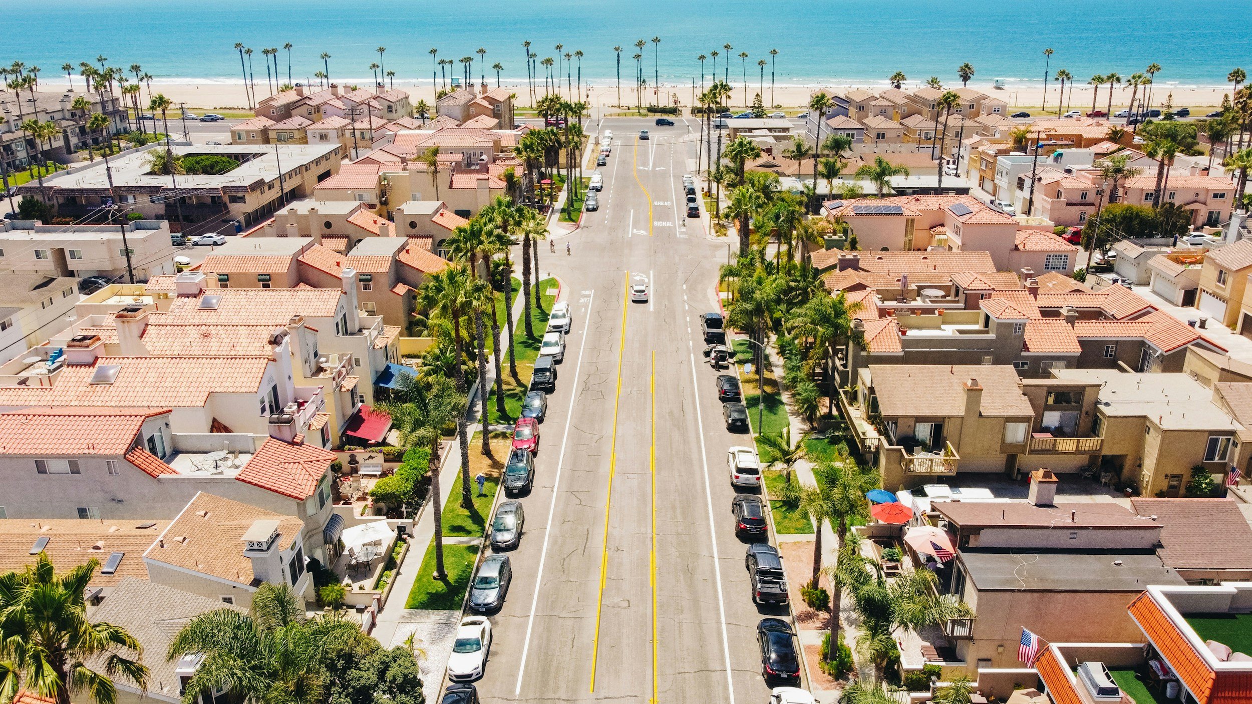 Huntington Beach street, houses, palm trees, coastline and ocean