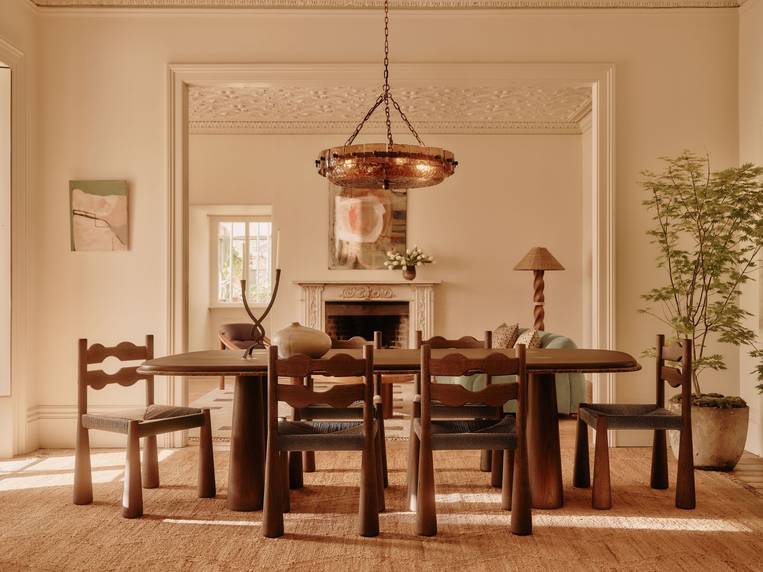 Soho Home AW26 dining room with wooden table and copper and glass chandelier lighting, photographed by Ryan Handy.