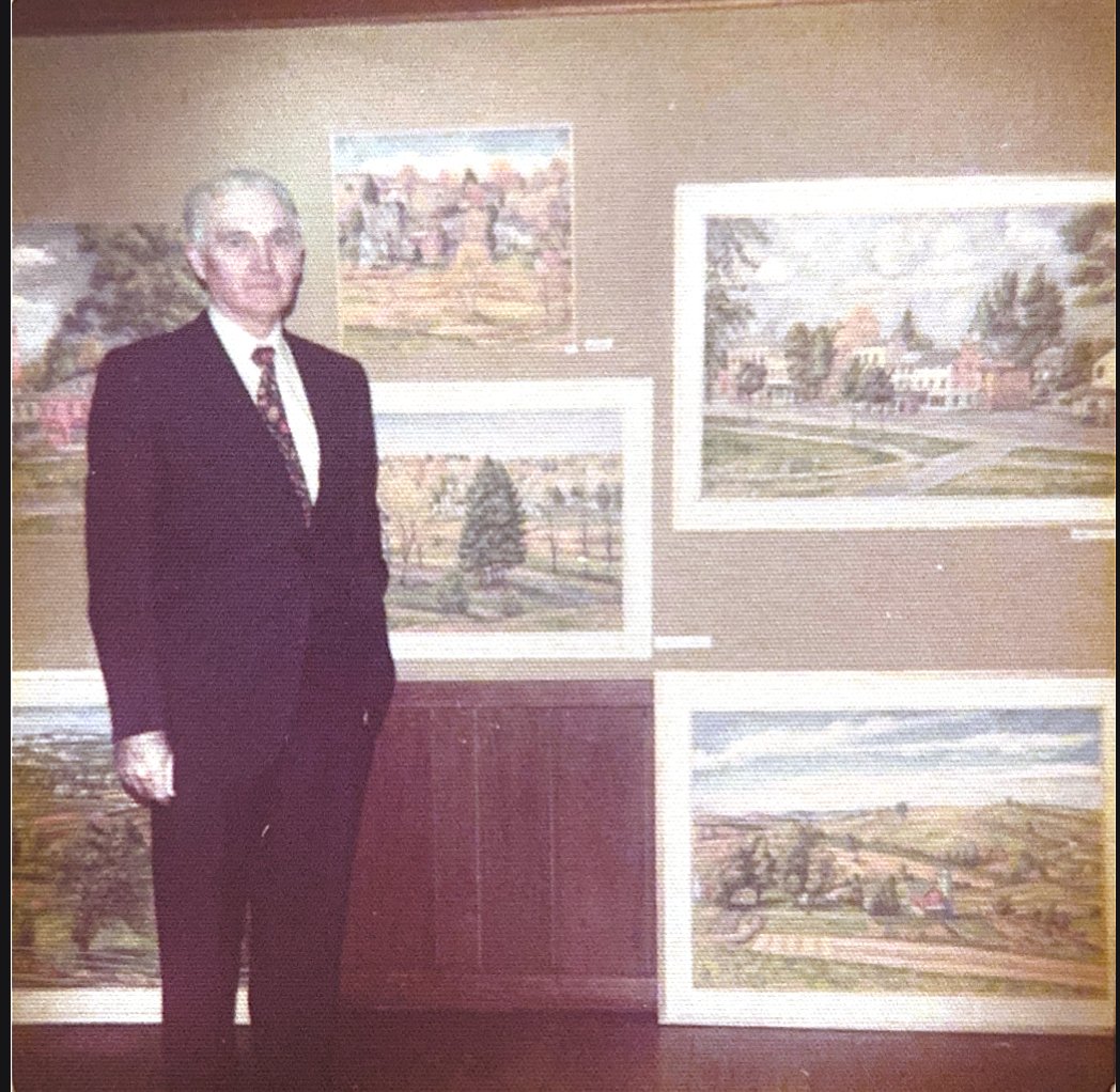 Frank with his art displayed at gallery 
