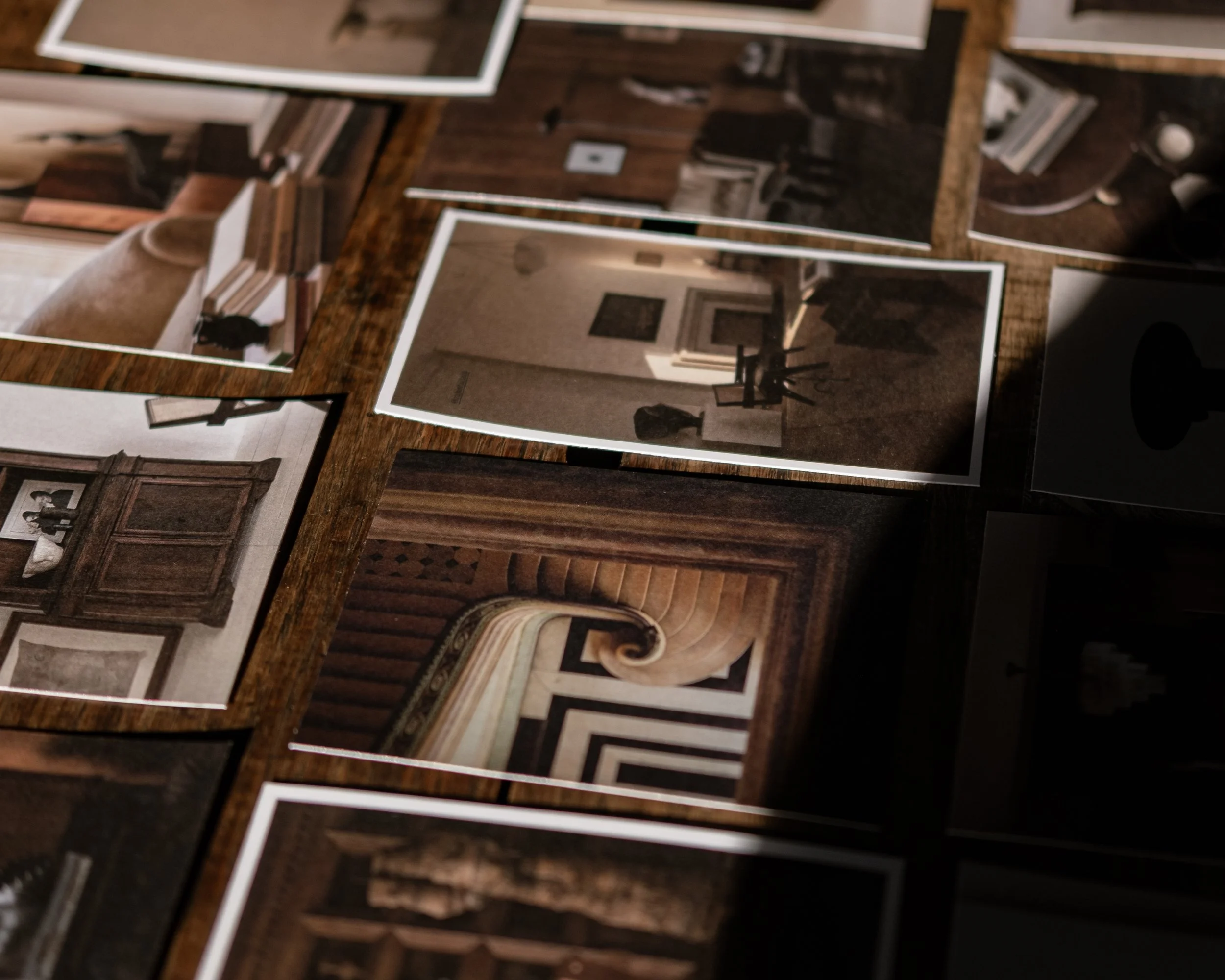 Elegant table setting with numerous lit candles in glass holders, a place setting with a menu and napkin, glassware, and decorative elements for a formal event or dinner party.