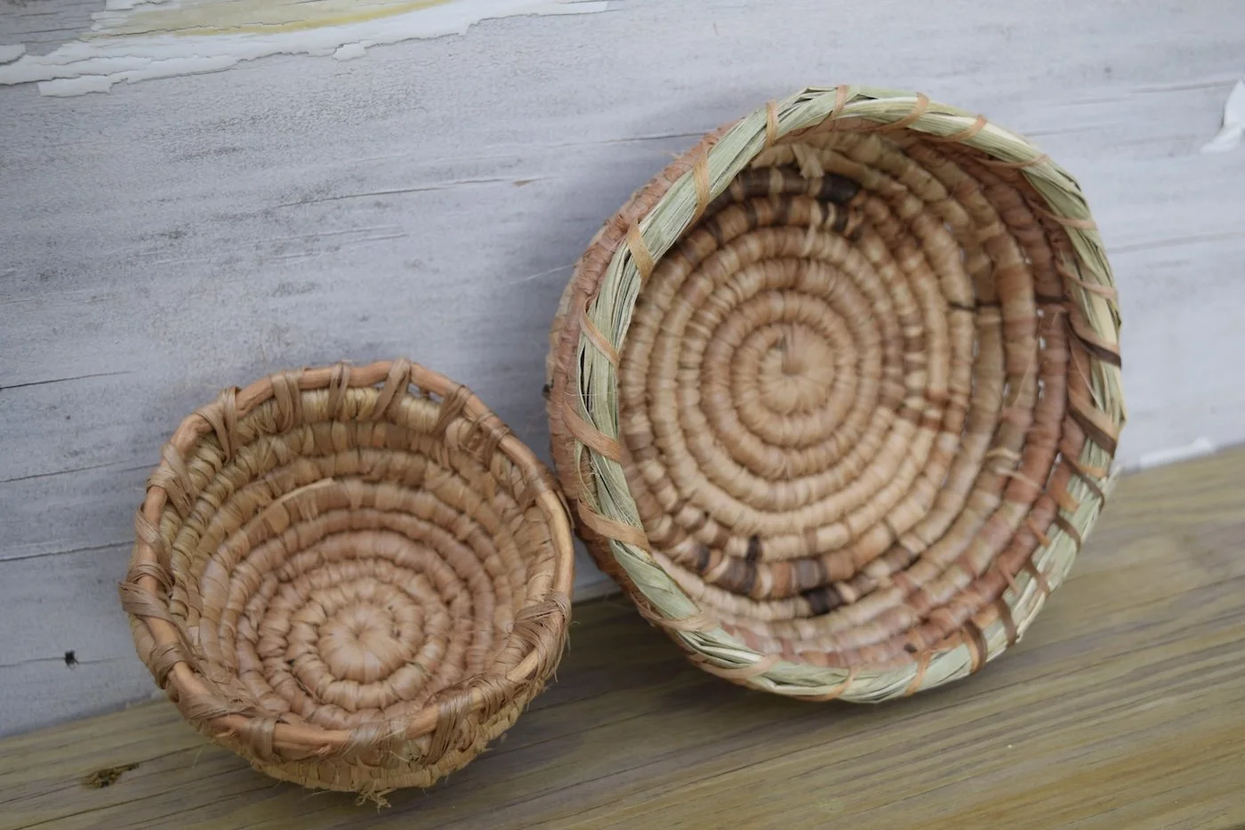 two closed coiled basswood fiber bowls