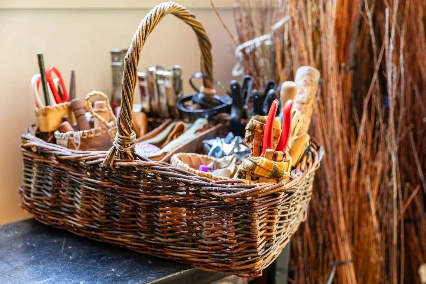 an image of a willow basket filled with basketry tools