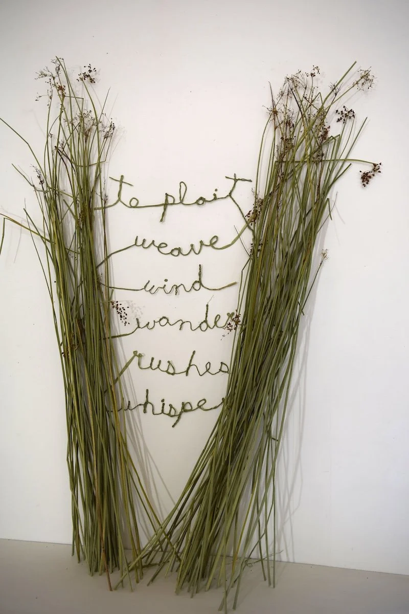 stack of rushes with words woven into them