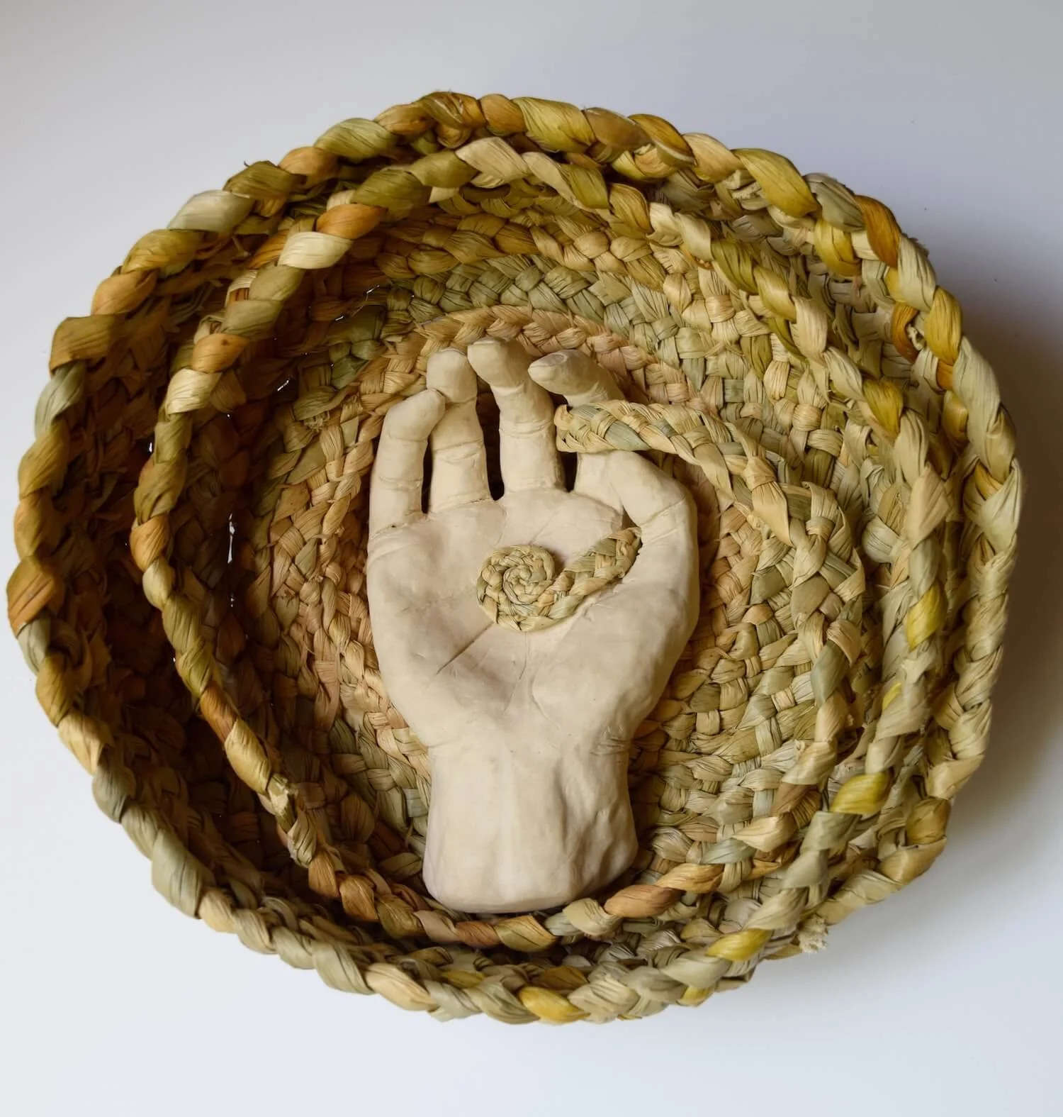 hand sculpture with plaited rushes