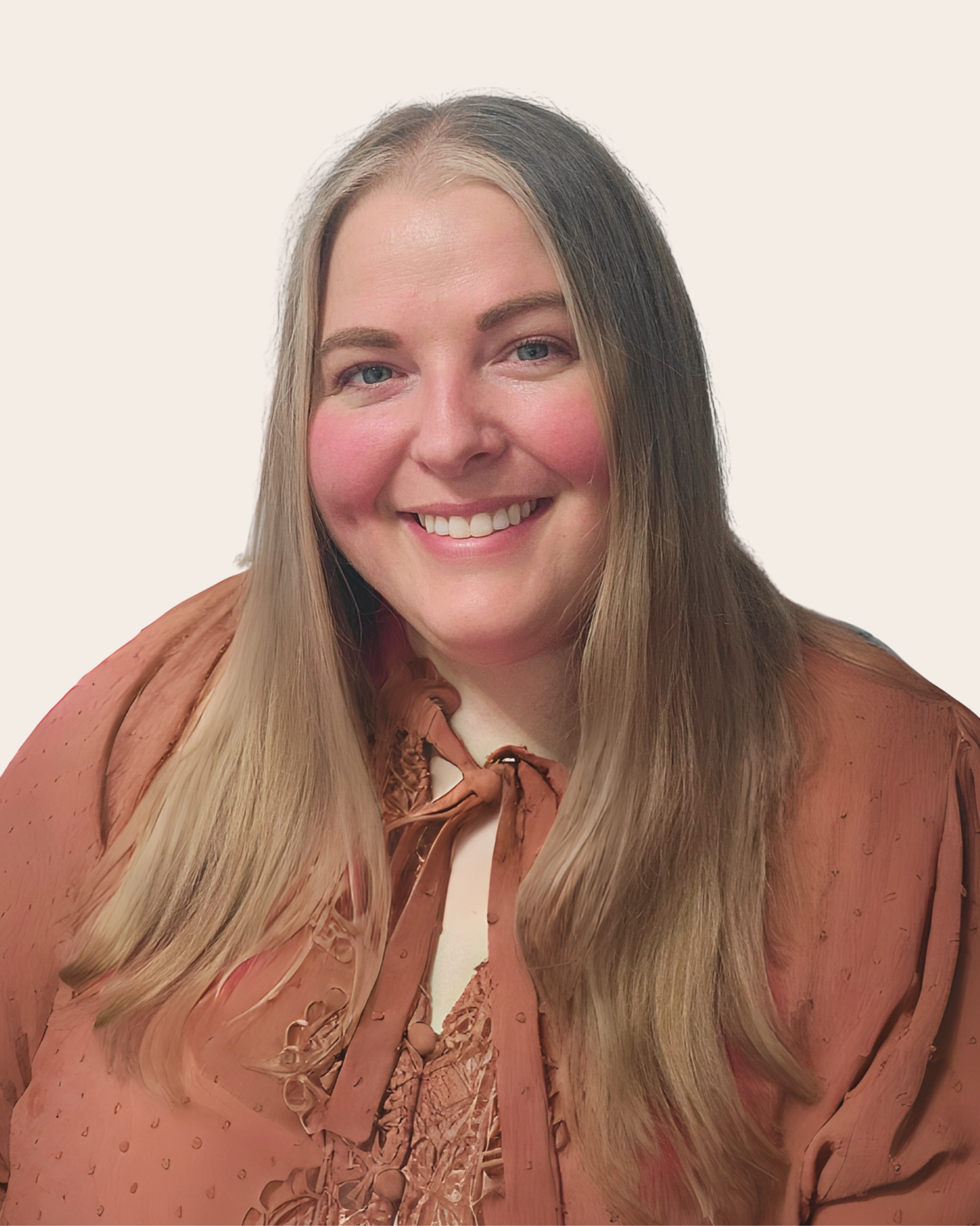 A smiling woman with long blonde hair, wearing a brown satin blouse with a bow tie.