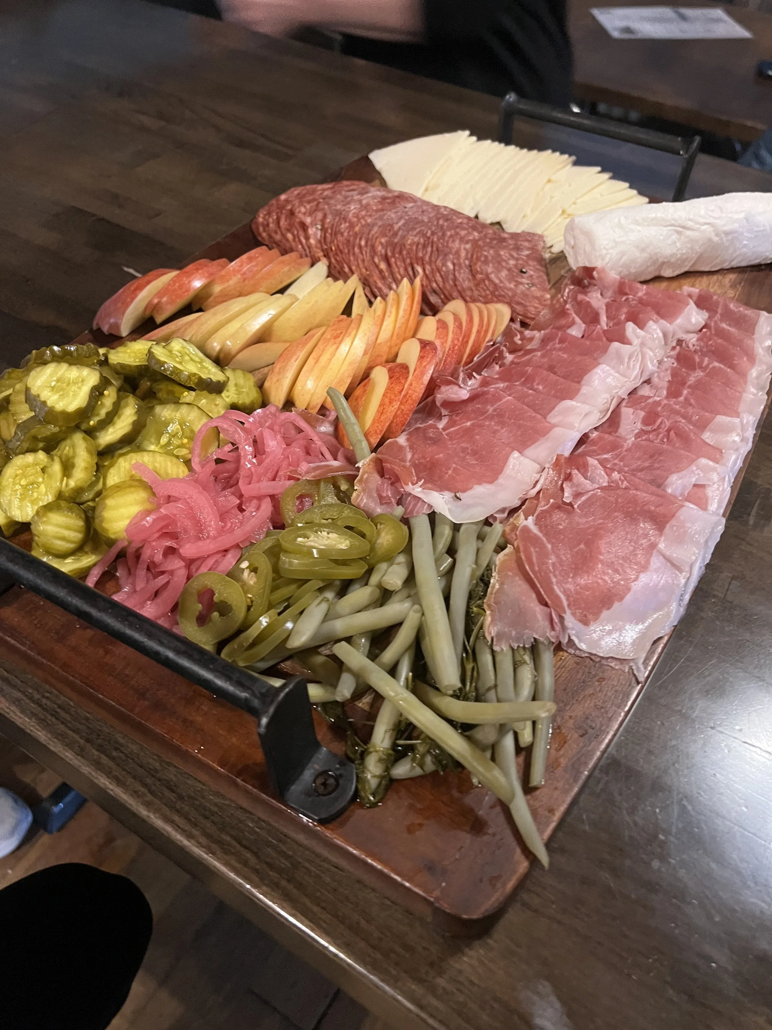 Sweat Crawl community gathering featuring charcuterie boards, appetizers, and drinks at Local Motive following a group wellness experience