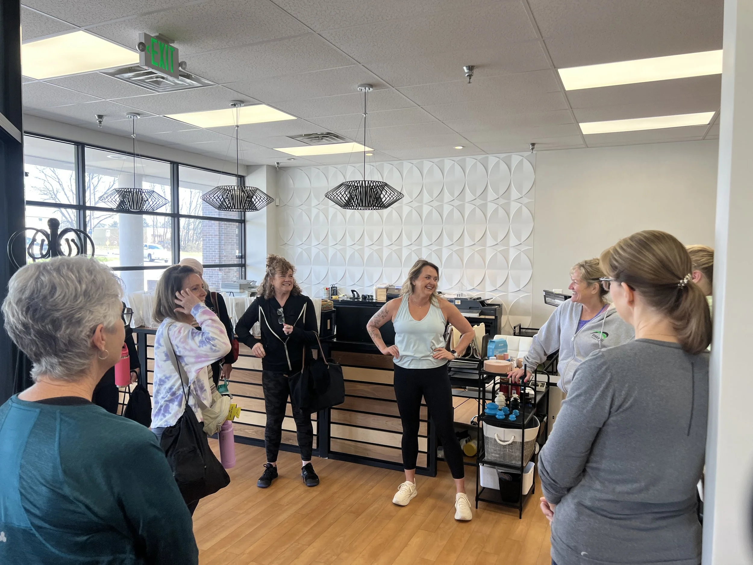 Participants beginning the Sweat Crawl with guided movement and mobility work at a physical therapy studio