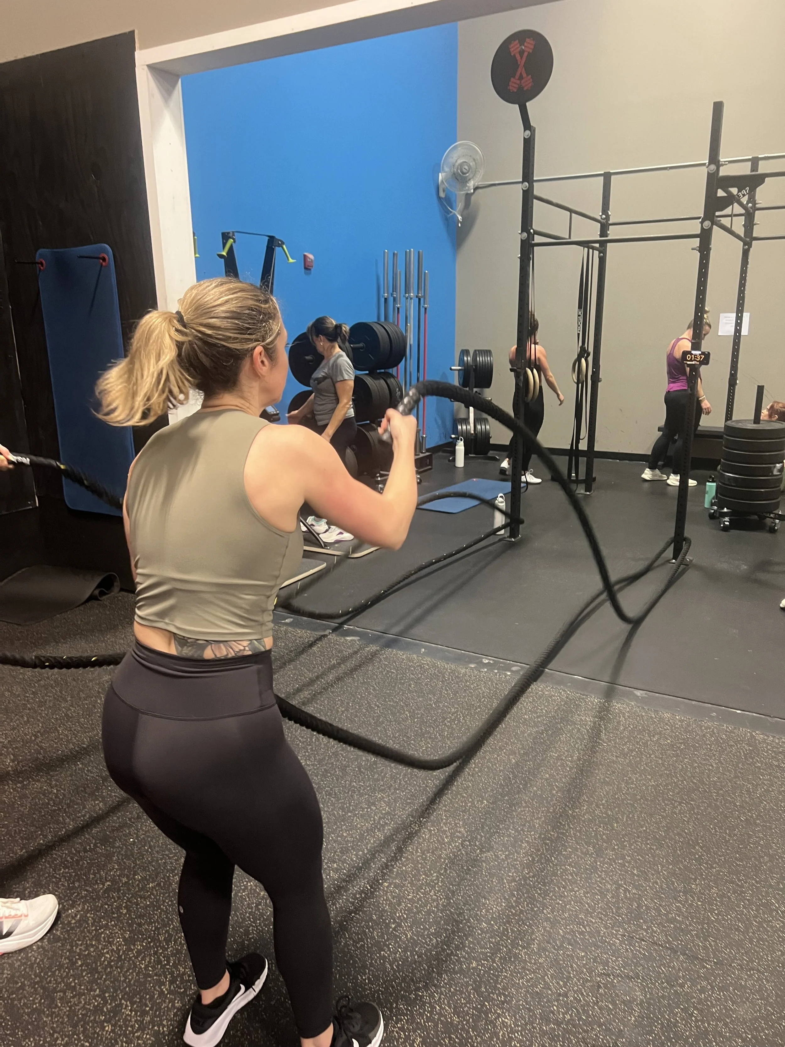 Sweat Crawl community engaging in a structured strength and conditioning workout at Elevate Gym