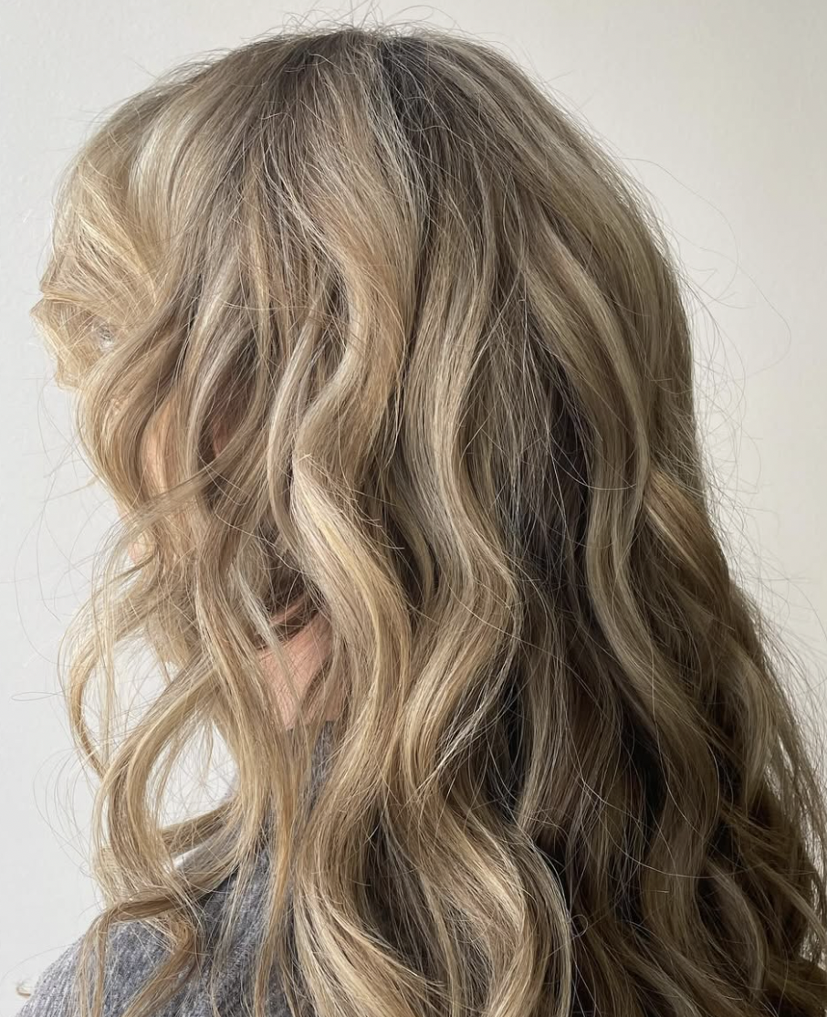 Wavy blonde hair viewed from the side.