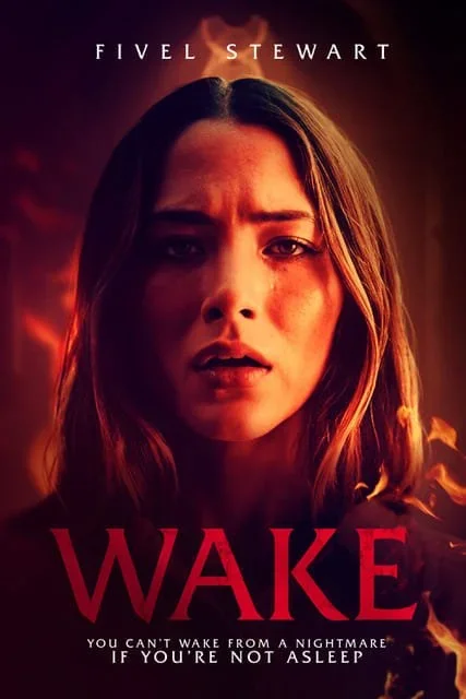 Close-up of a worried woman with long dark hair and a serious expression, with a fiery background, movie title 'WAKE', and actress Fivel Stewart's name.