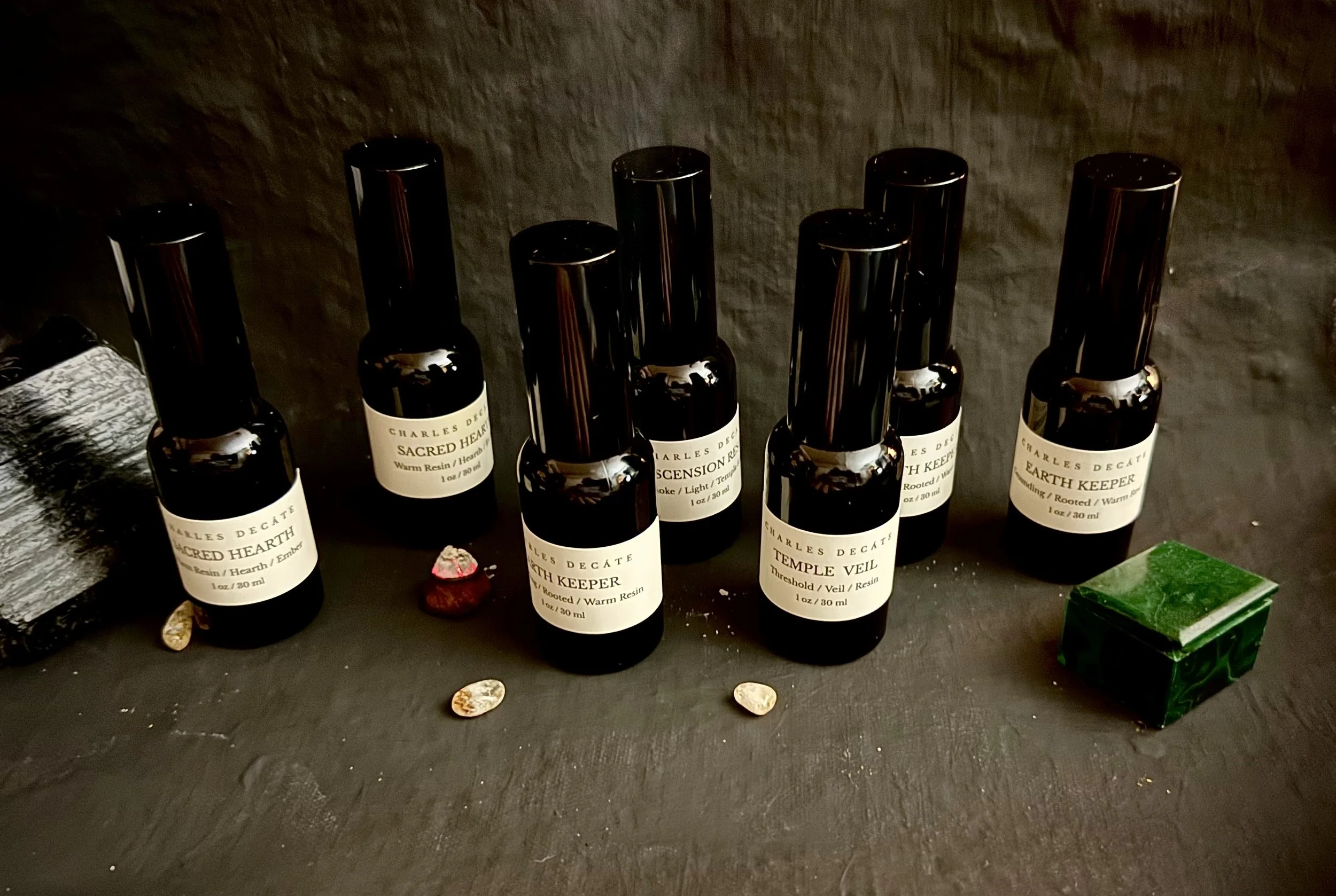 Handcrafted Temple Fragrance perfume sprays from Charles Decáte's Temple Series, Including Temple Veil, Earth Keeper, Sacred Hearth, and Ascension Resin.