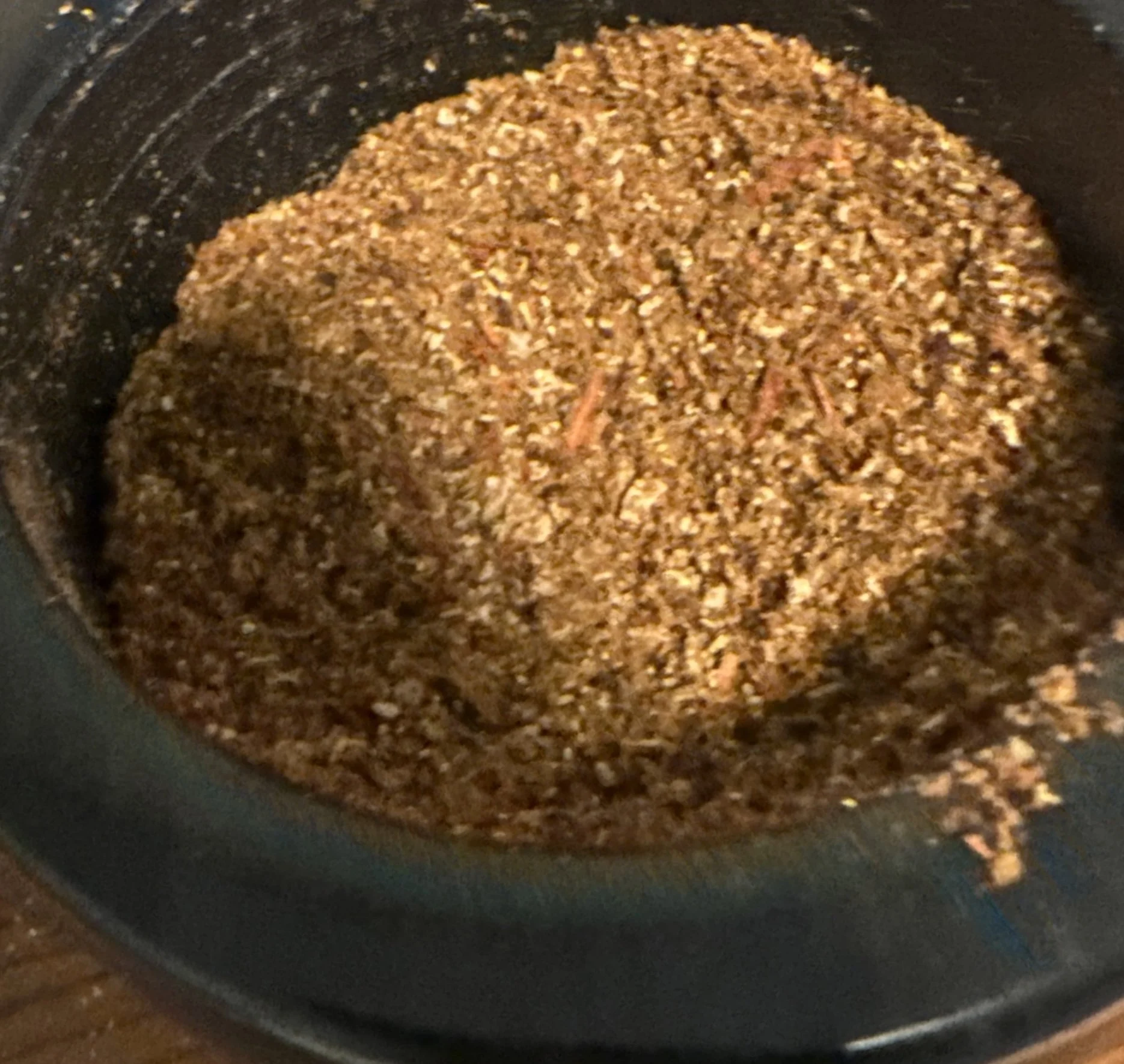 Handcrafted Temple Incense herbal blend in a mortar, prepared by Charles Decáte from aromatic plant materials for ritual incense.