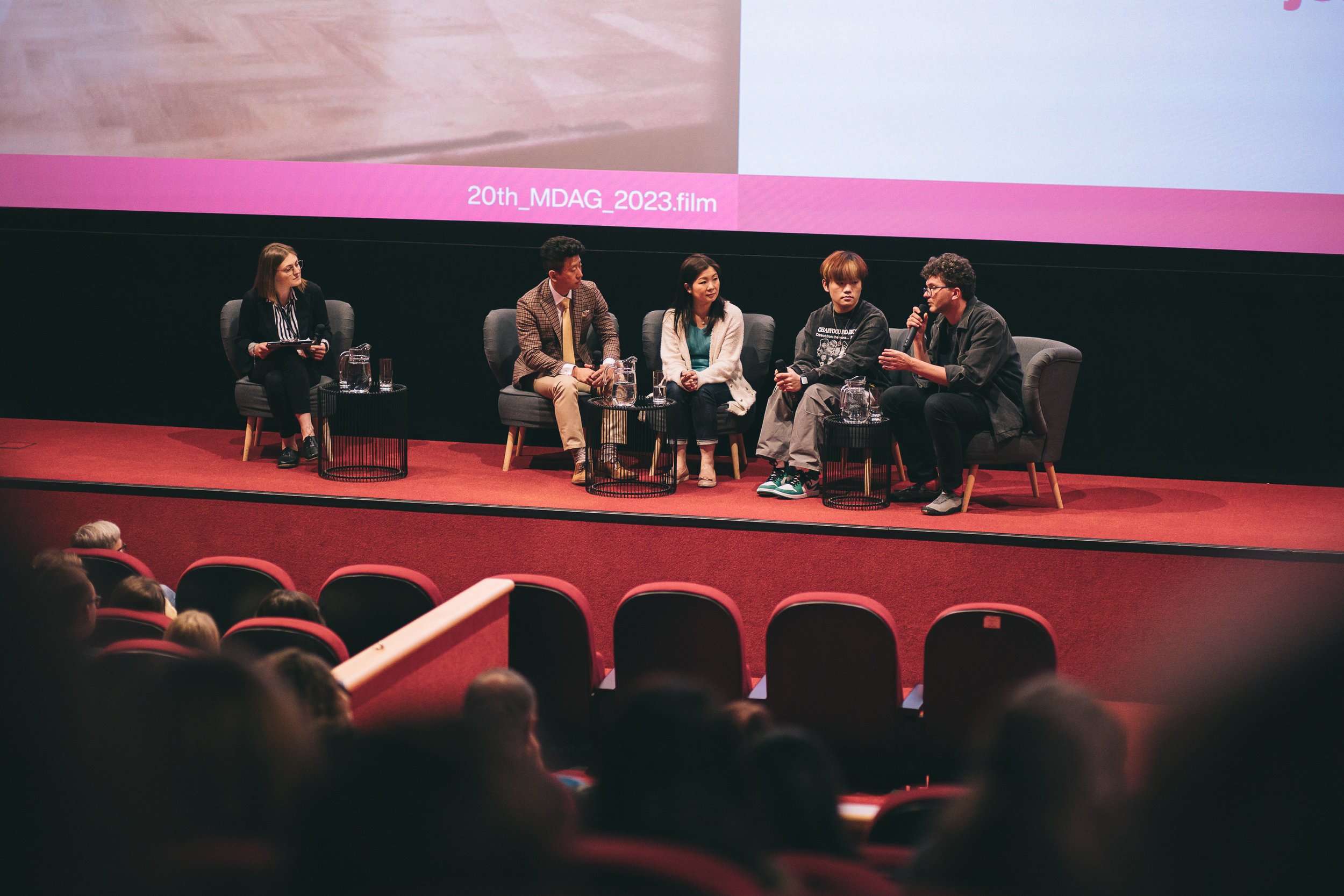 Documentary film Pianoforte Polish Premiere with Hao Rao, Vivian Li, Jakub Piatek. The stage has a large screen backdrop with the text '20th_MDAG_2023.film' visible.