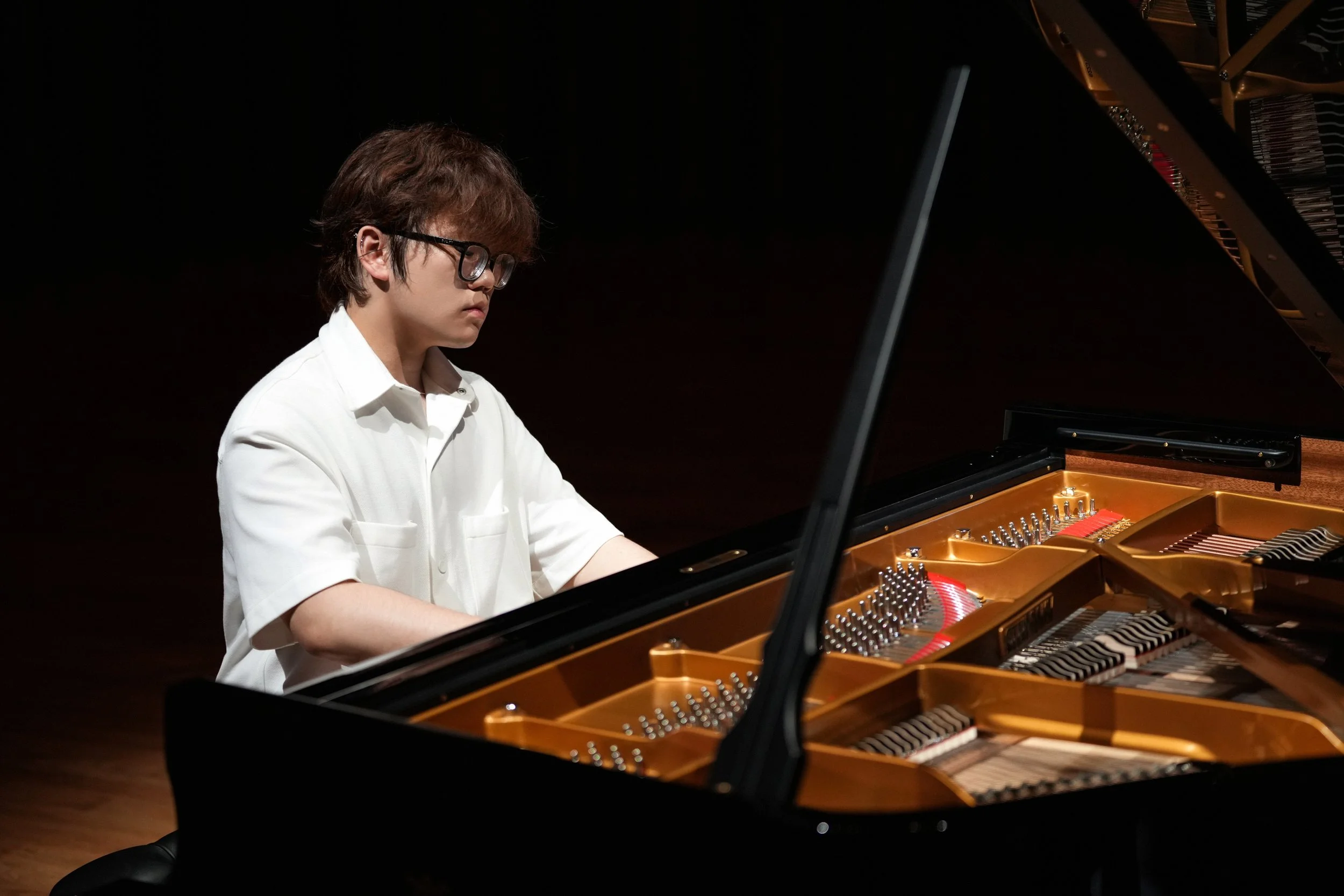 Hao Rao, pianist, performing on grand piano during a concert recital.